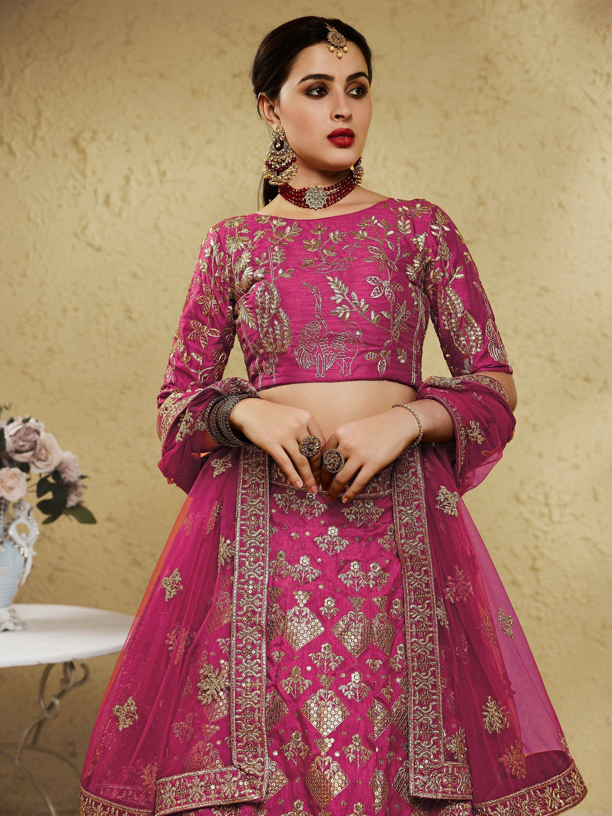 Pink embroidered lehenga choli with gold detailing, perfect for Indian weddings and festive occasions.
