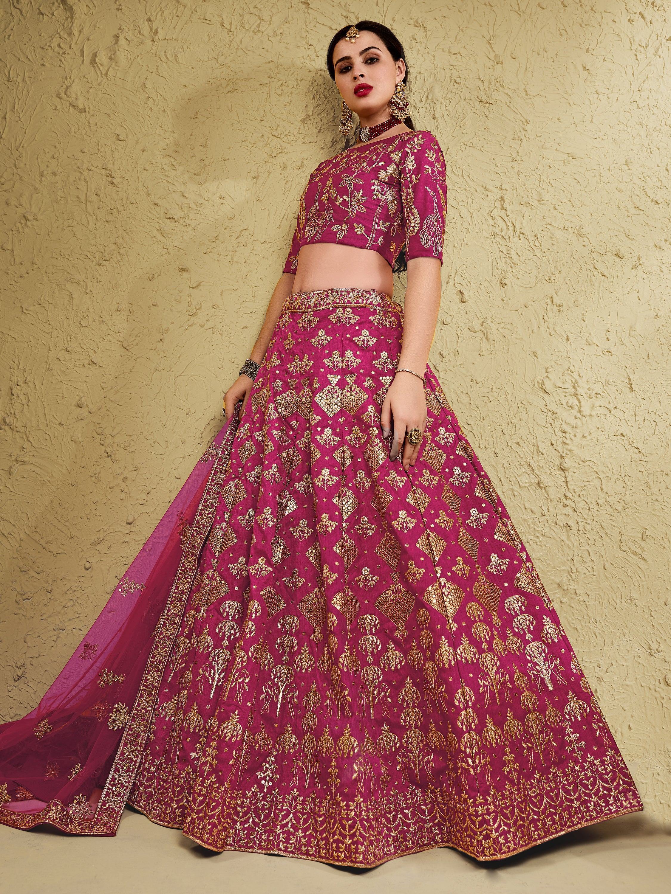 Elegant magenta lehenga choli with gold embroidery, perfect for Indian weddings and festive occasions.