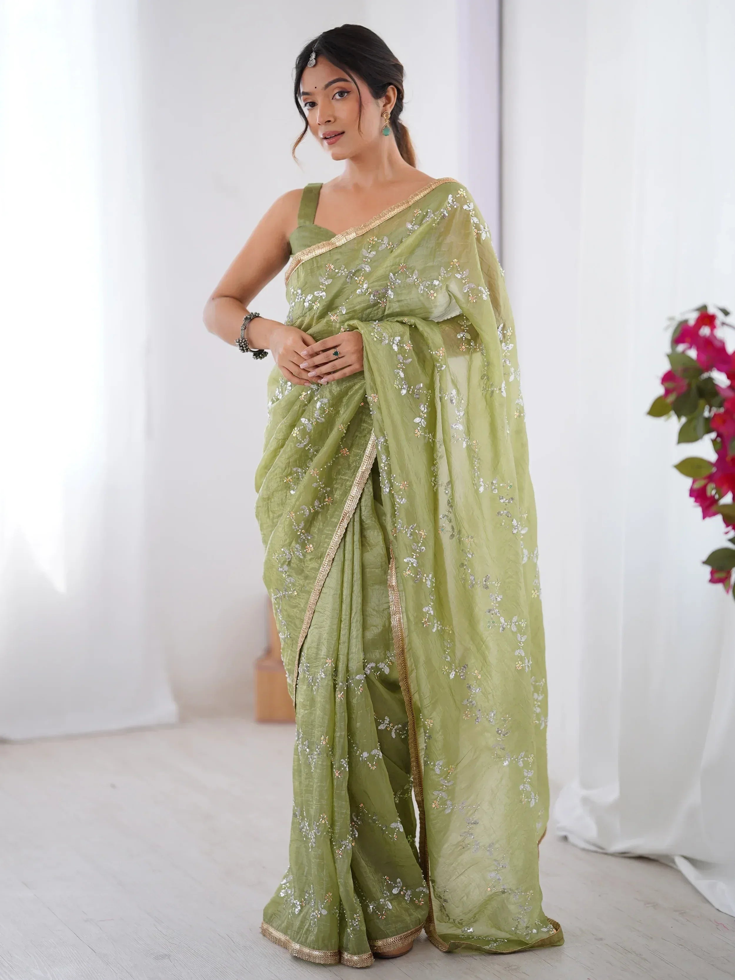 Light green embroidered saree with gold border, perfect for Indian ethnic wear occasions