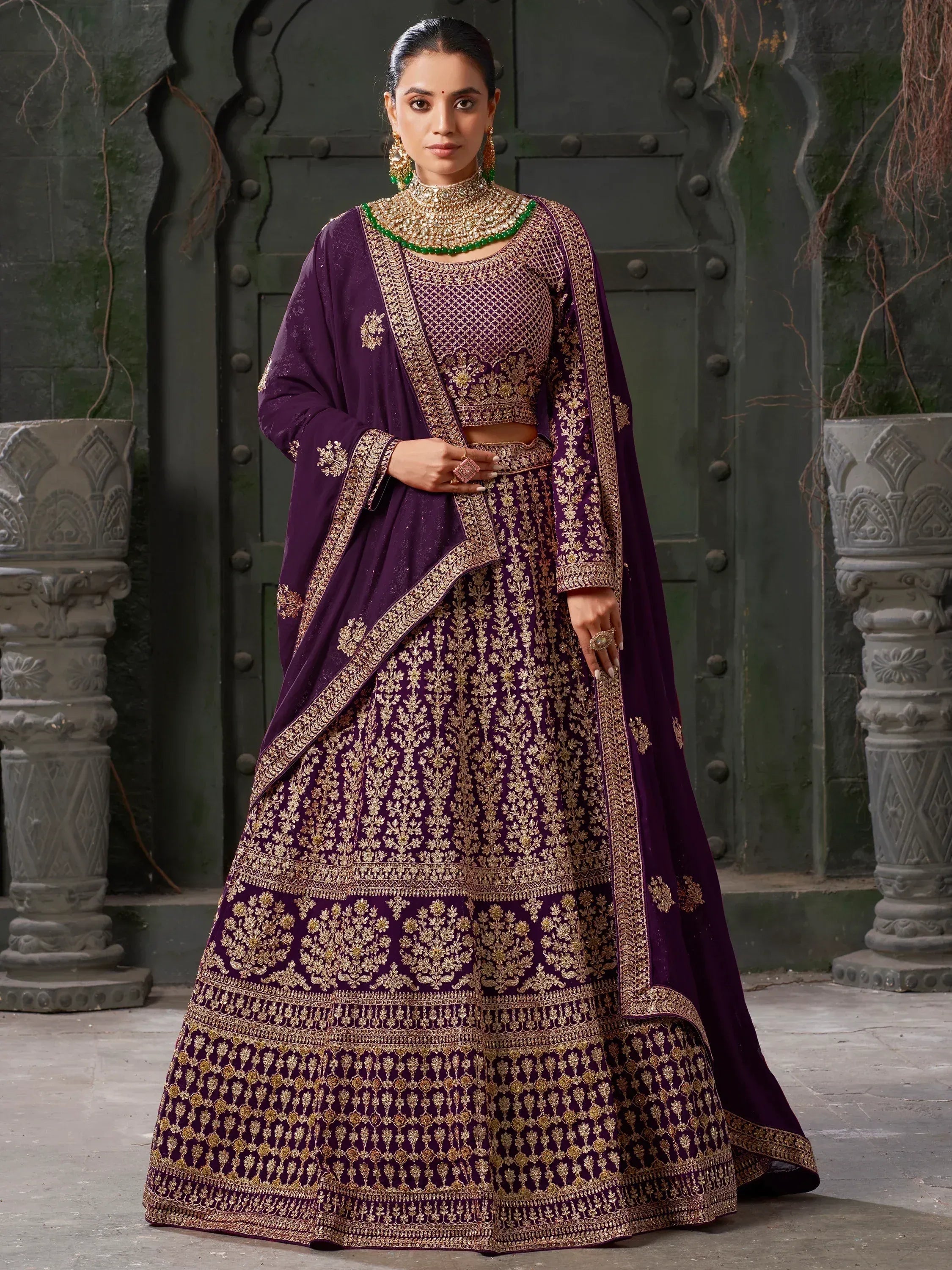 Purple designer lehenga choli with gold embroidery, perfect for Indian weddings and festive occasions.