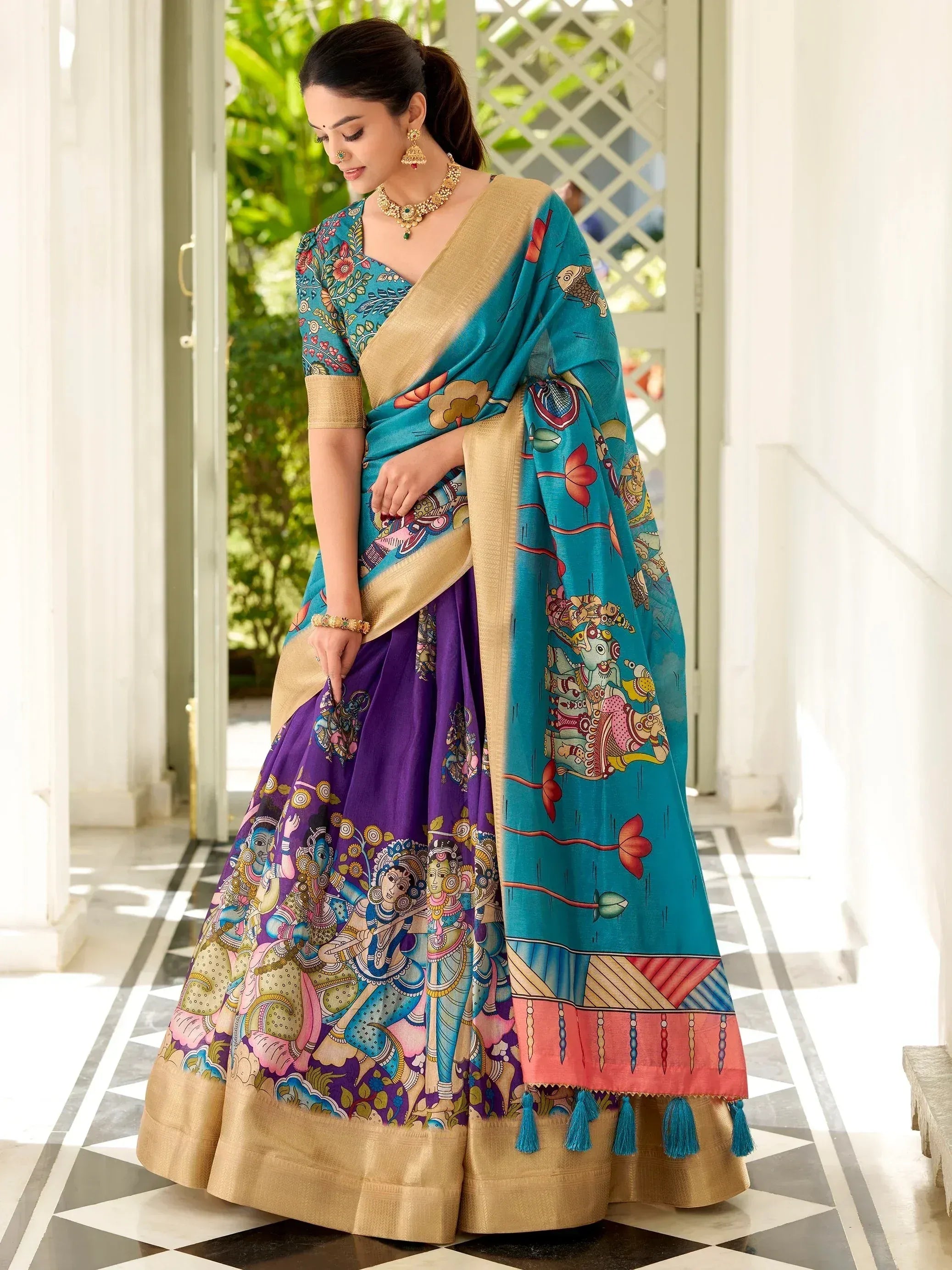 Woman in vibrant purple and teal printed lehenga choli with gold border, traditional Indian ethnic wear