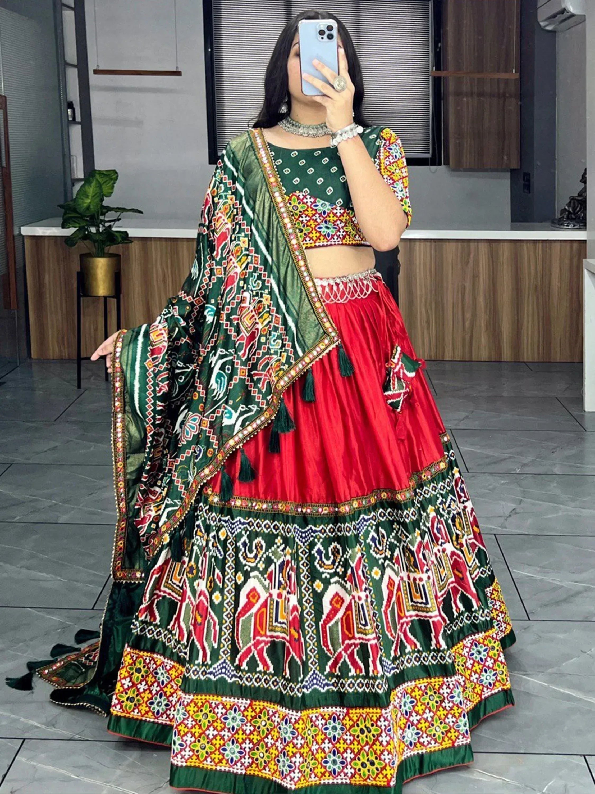 Green and red embroidered lehenga choli with mirror work and elephant motifs, traditional Indian ethnic wear