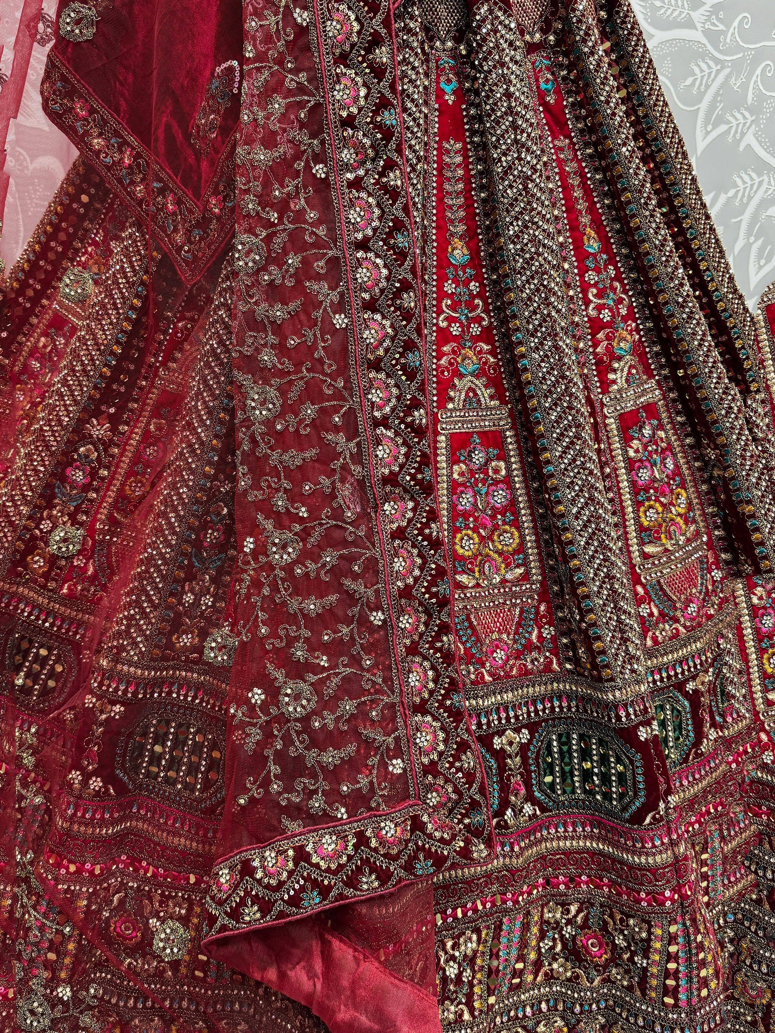 Luxury maroon lehenga choli with heavy embroidery and sequins, perfect for Indian weddings and festive occasions.