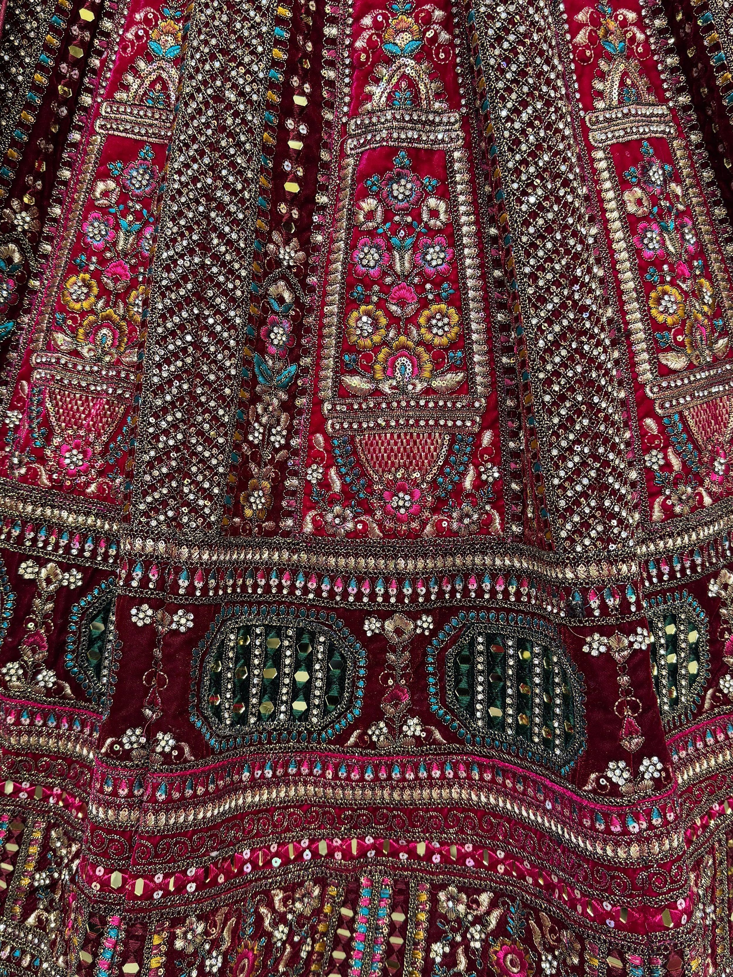 Richly embroidered maroon Indian ethnic wear with floral motifs, sequins, and mirror work for festive occasions