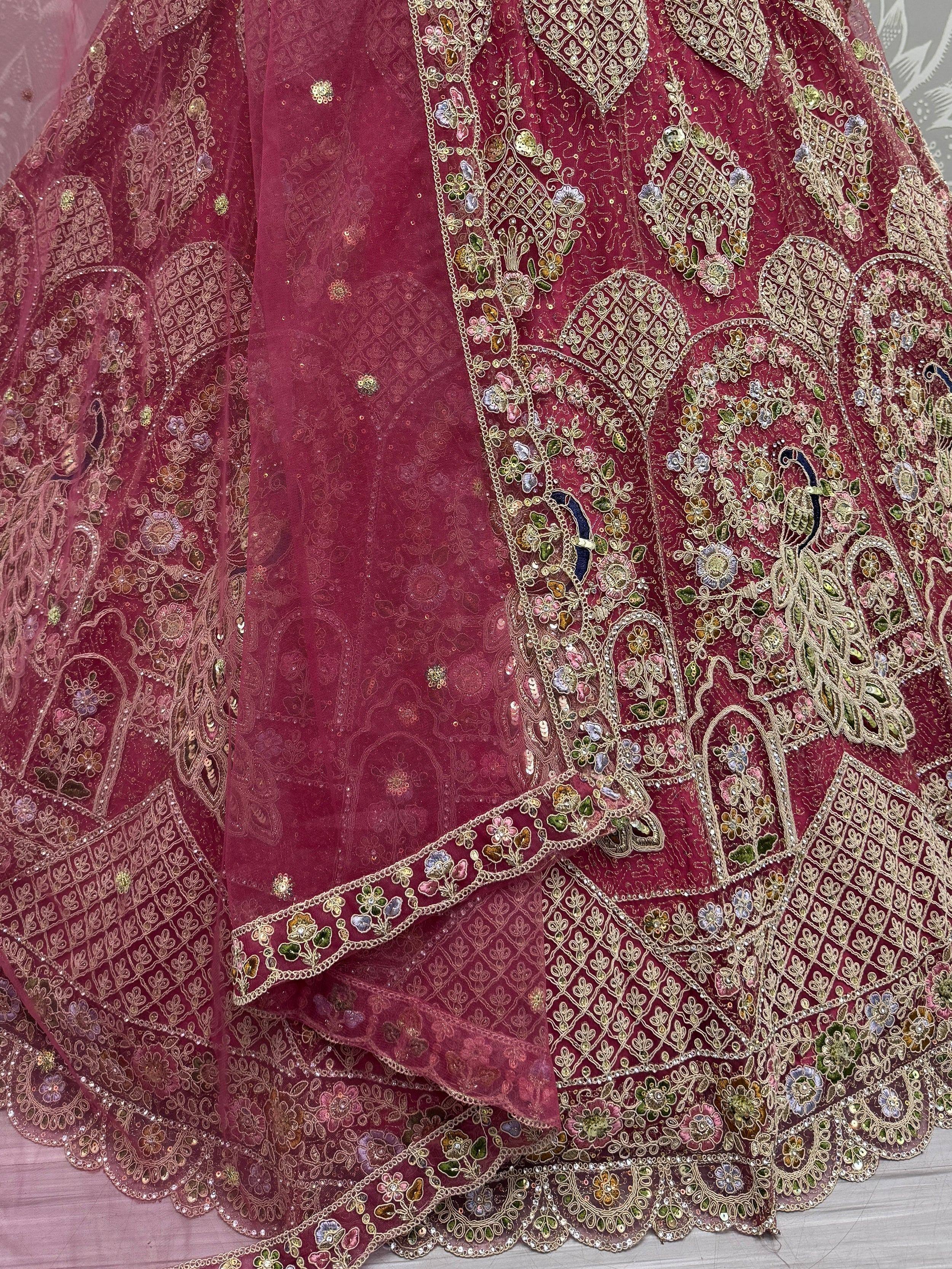 Luxury maroon lehenga with intricate gold embroidery and floral motifs, perfect for Indian weddings and festive occasions.