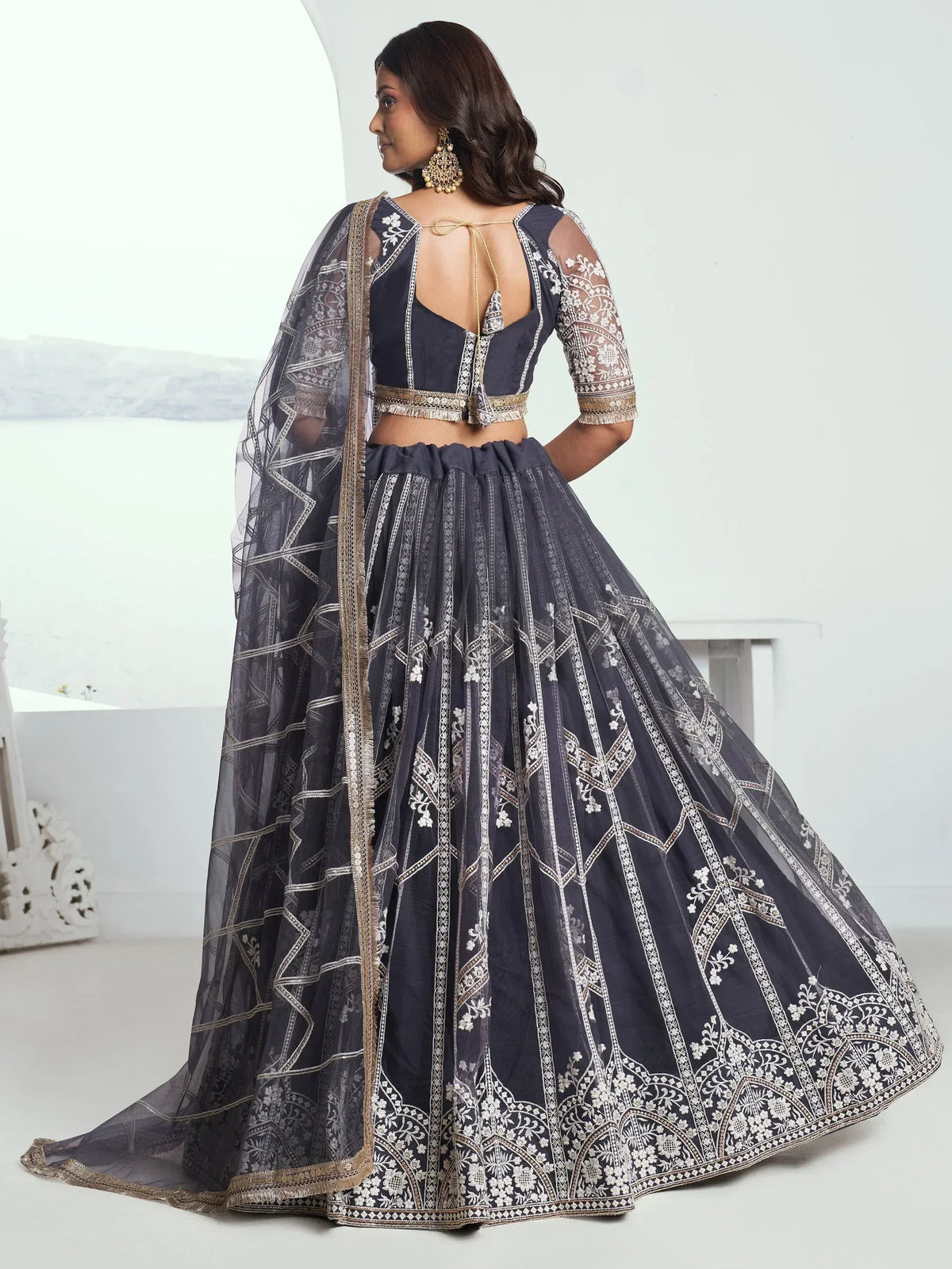 Navy blue embroidered lehenga choli with sheer dupatta, perfect for Indian weddings and festive occasions.