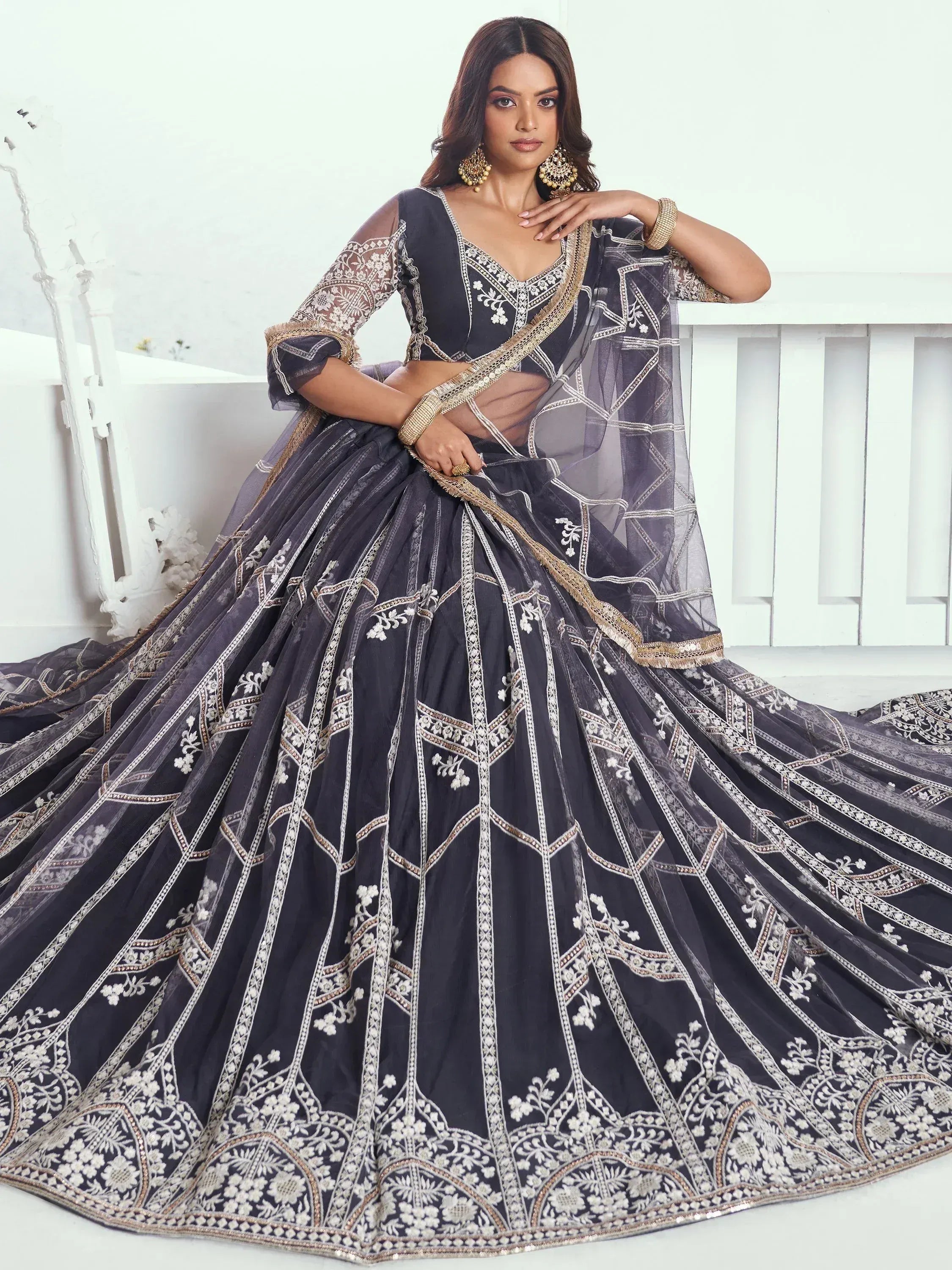 Elegant navy blue lehenga choli with intricate white and gold embroidery, perfect for Indian ethnic wear occasions.