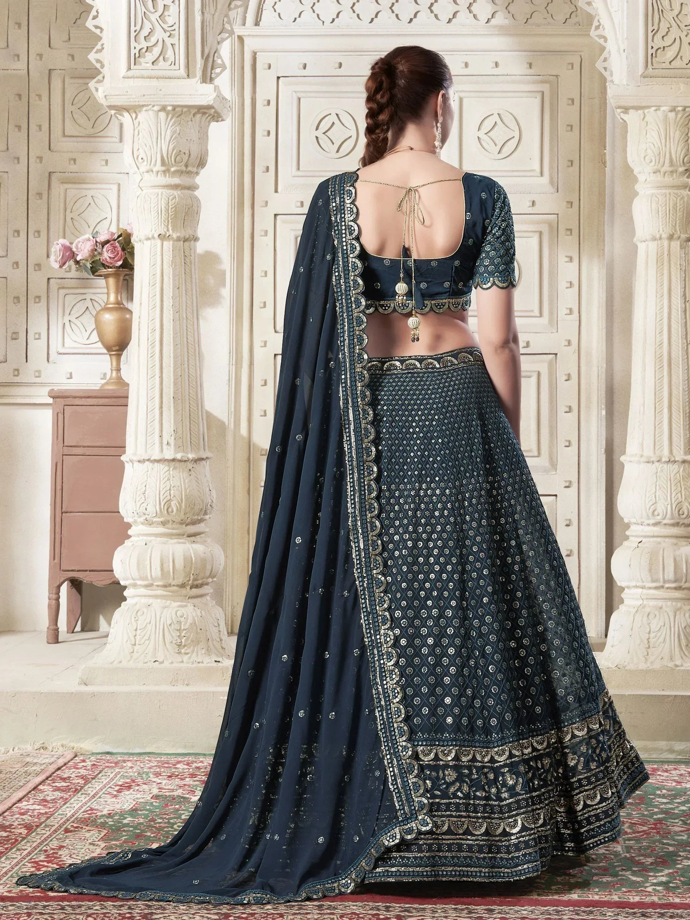 Navy blue designer lehenga choli with gold embroidery, back view, ethnic Indian wear
