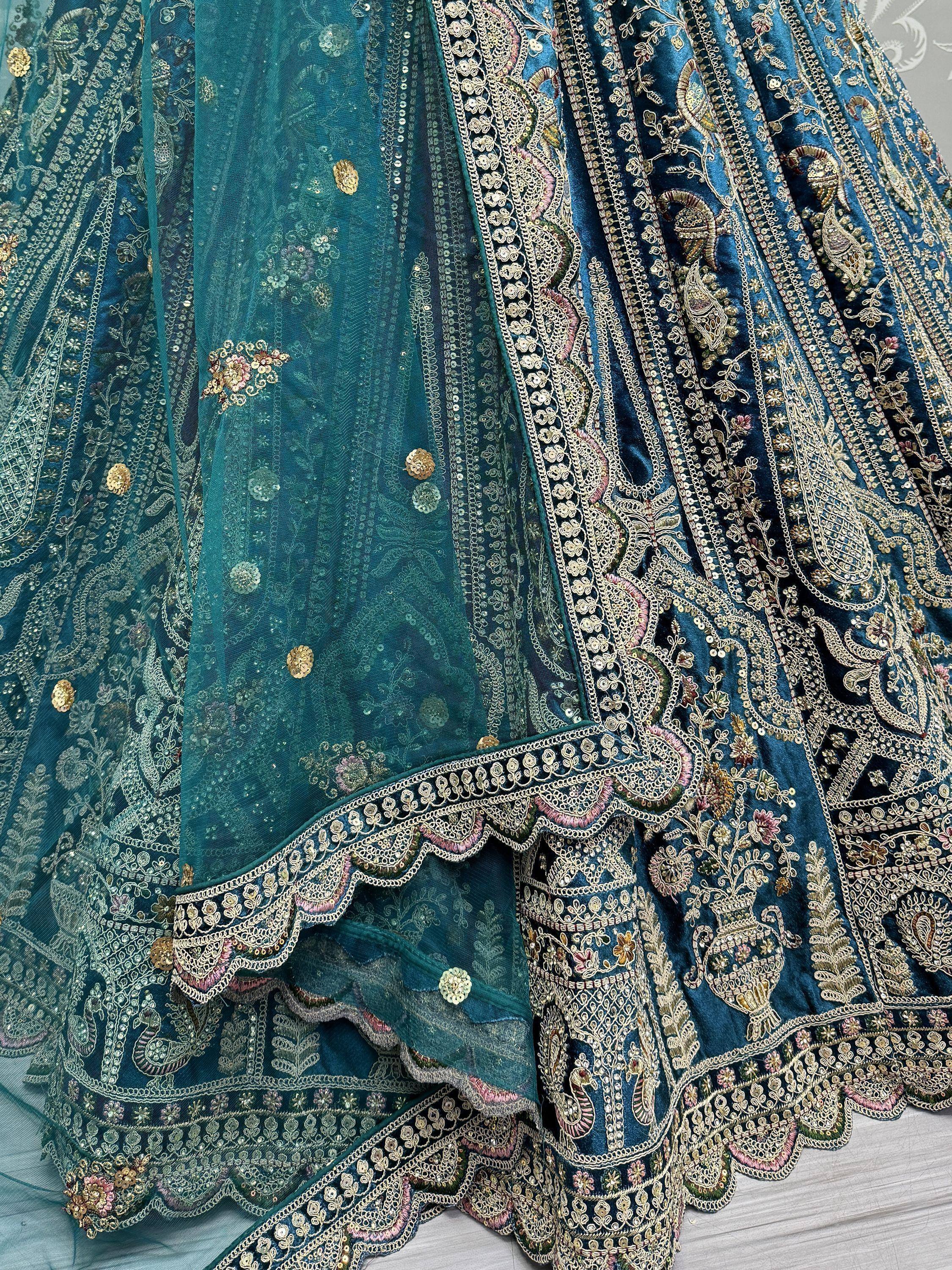 Teal blue designer lehenga choli with heavy gold embroidery and sequin work, perfect for weddings and festivals.