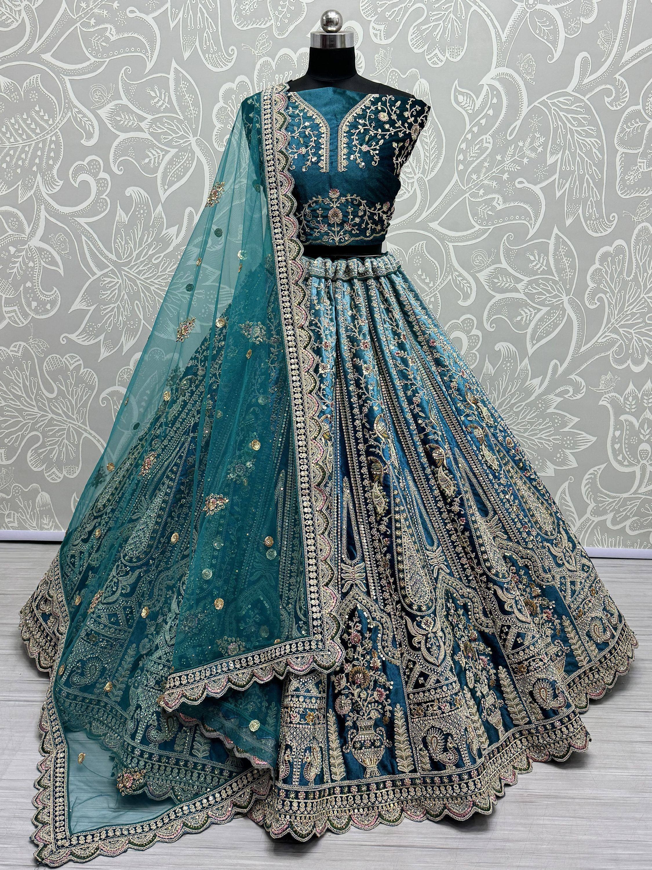 Teal designer lehenga choli with heavy gold embroidery and matching dupatta, ideal for Indian weddings and festive occasions.