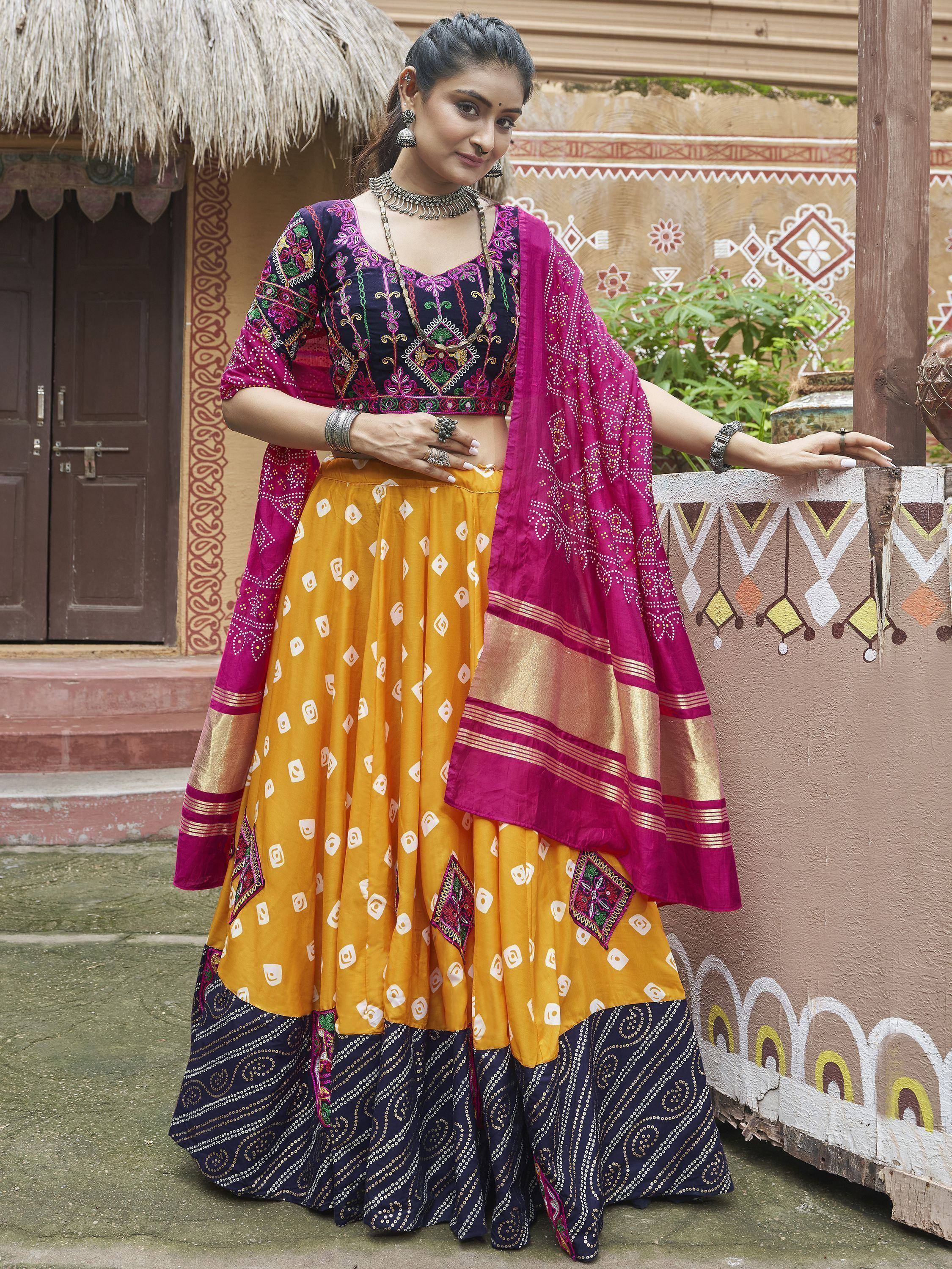 Woman in vibrant Indian ethnic lehenga choli with embroidered blouse, yellow skirt, and pink dupatta, styled for festive occasions.