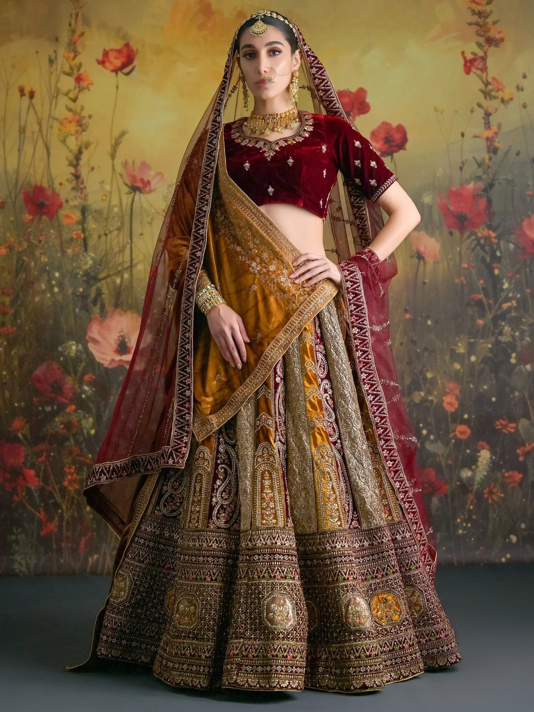 Luxury maroon and gold embroidered lehenga choli with dupatta, perfect for Indian weddings and festive occasions.