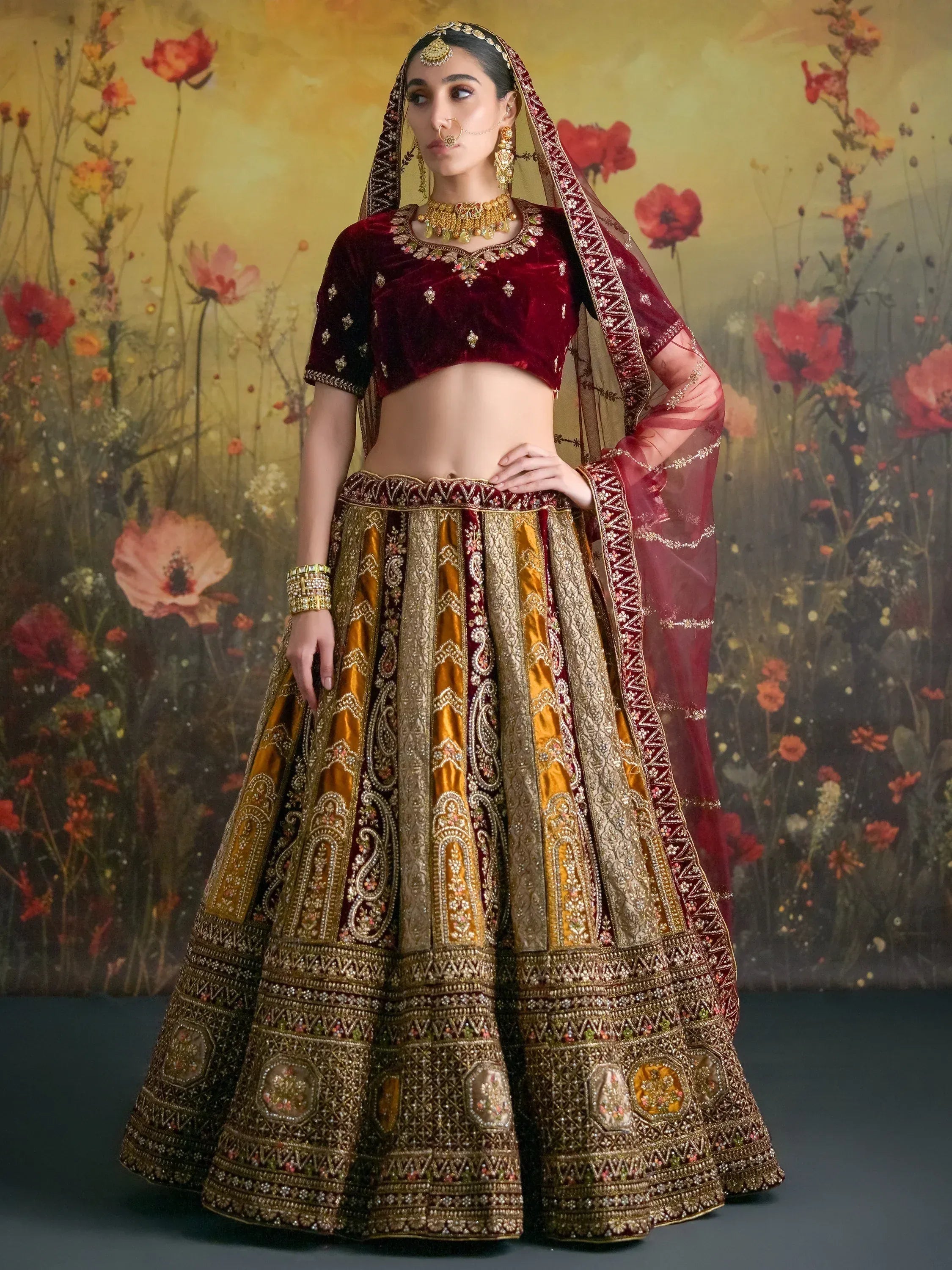 Maroon and gold designer lehenga choli with heavy embroidery, perfect for Indian weddings and festive occasions.