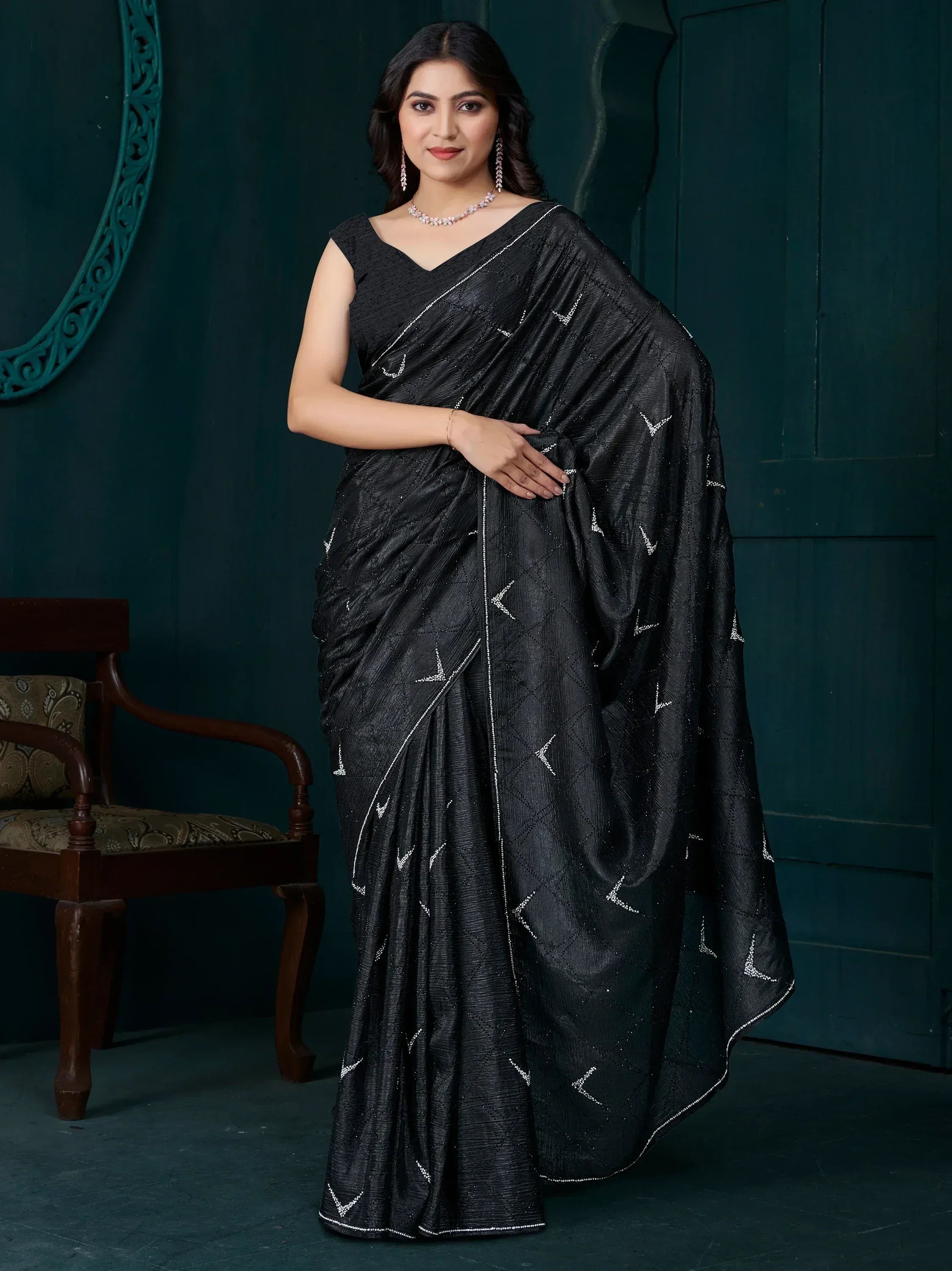Elegant black saree with silver geometric embroidery, perfect for Indian ethnic wear occasions.