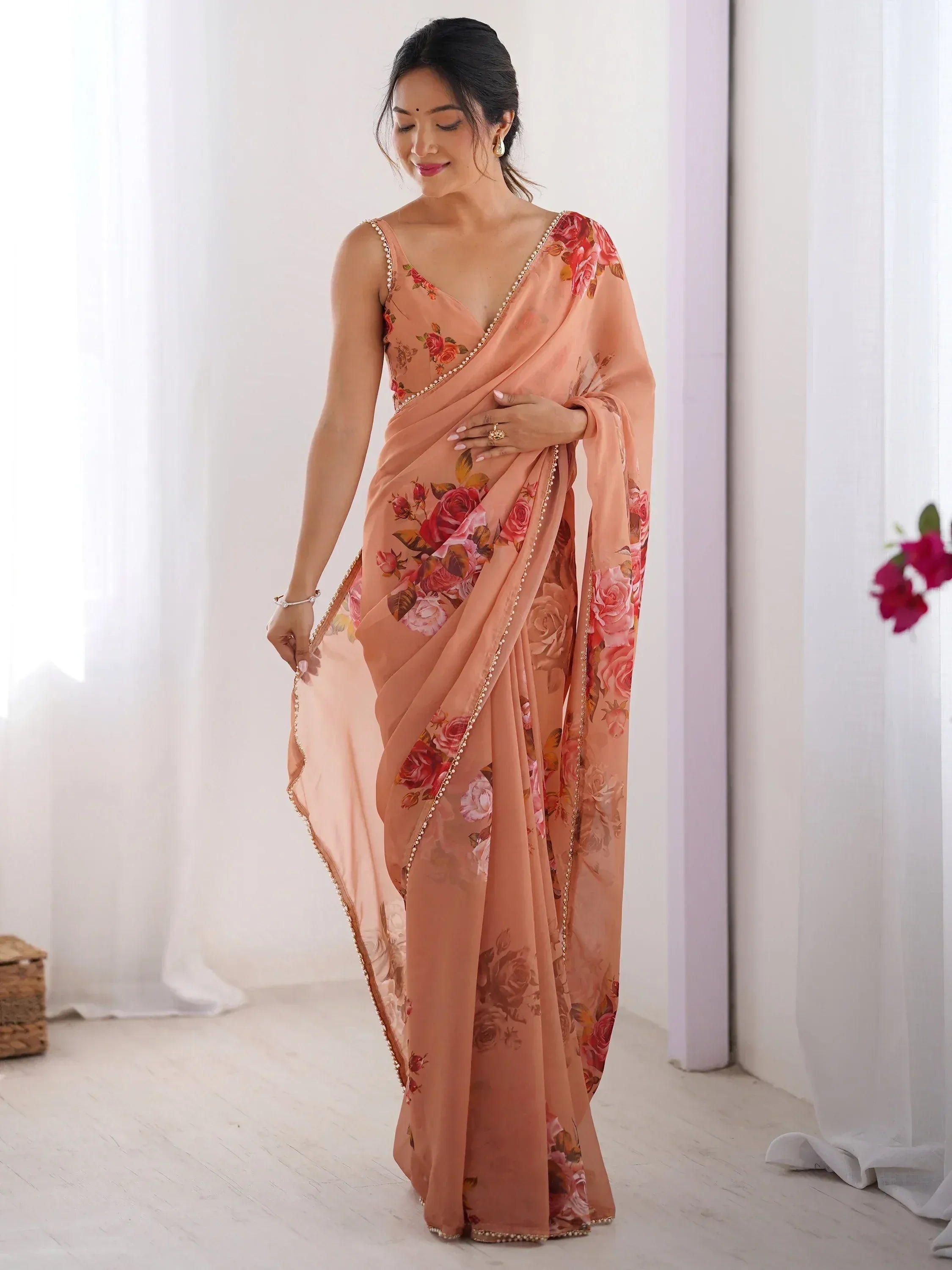 Peach floral saree with pearl border, elegant Indian ethnic wear for women