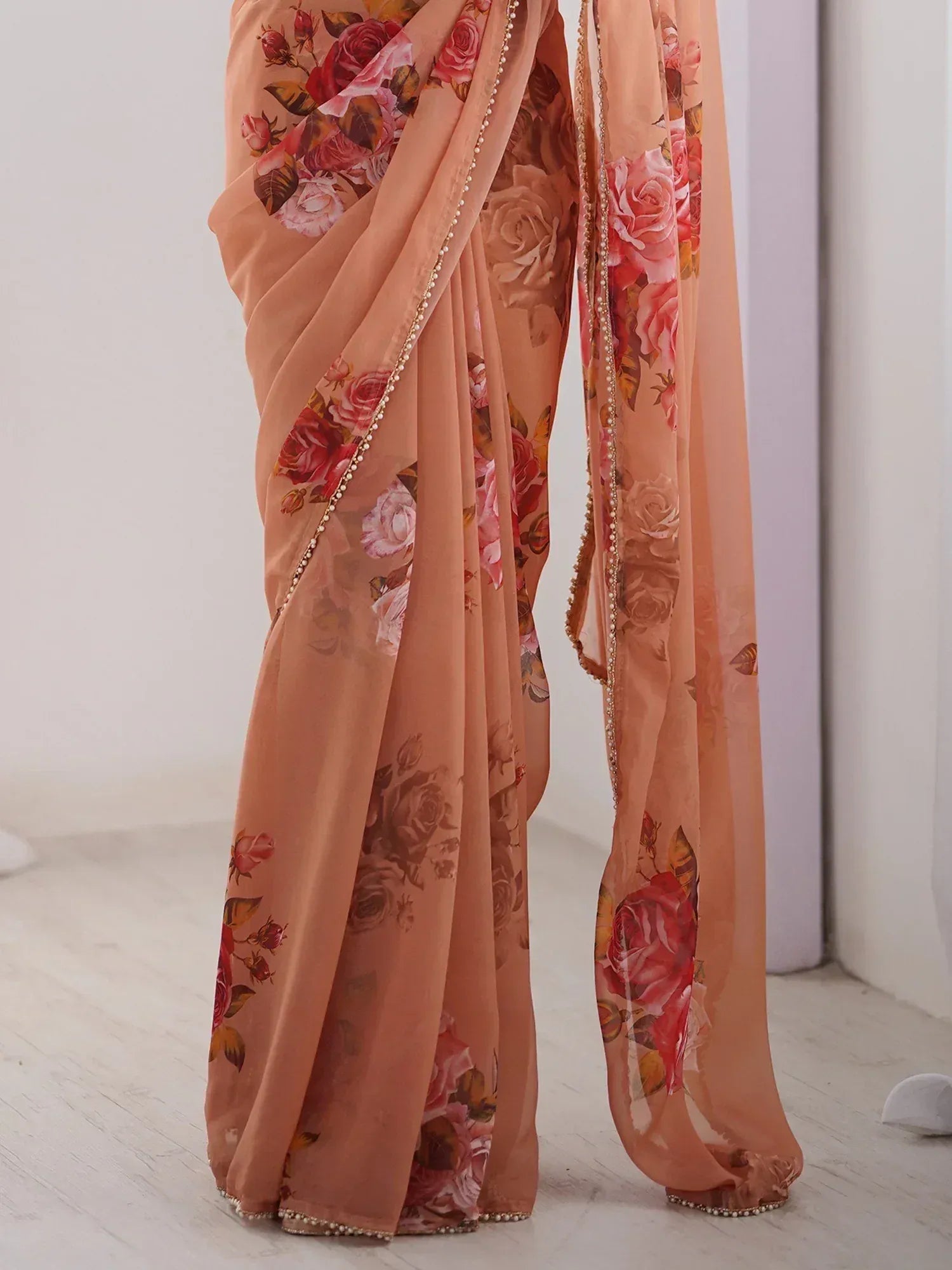 Peach floral saree with pearl border, elegant Indian ethnic wear for women