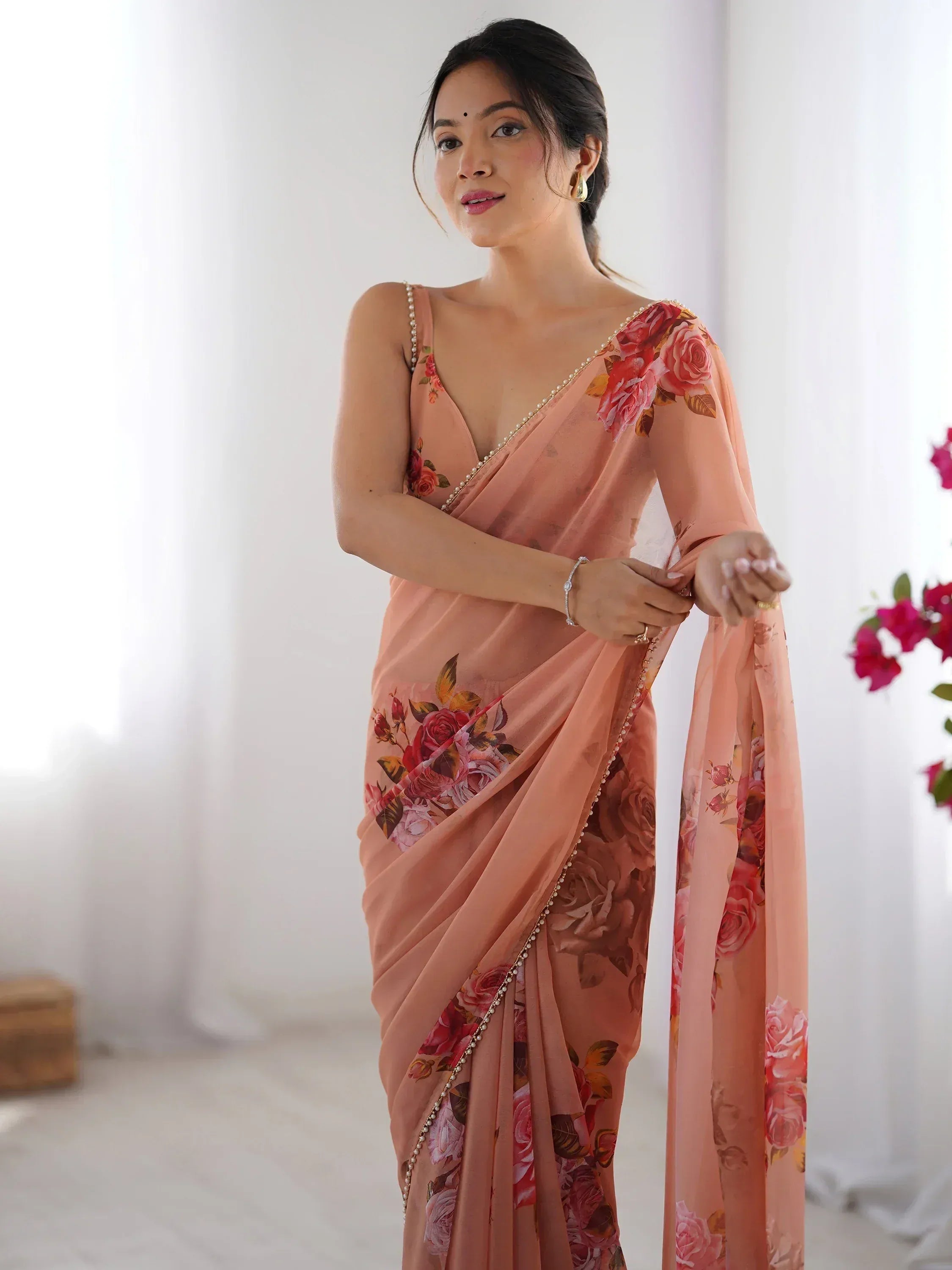 Pink floral saree with pearl trim, elegant Indian ethnic wear for women