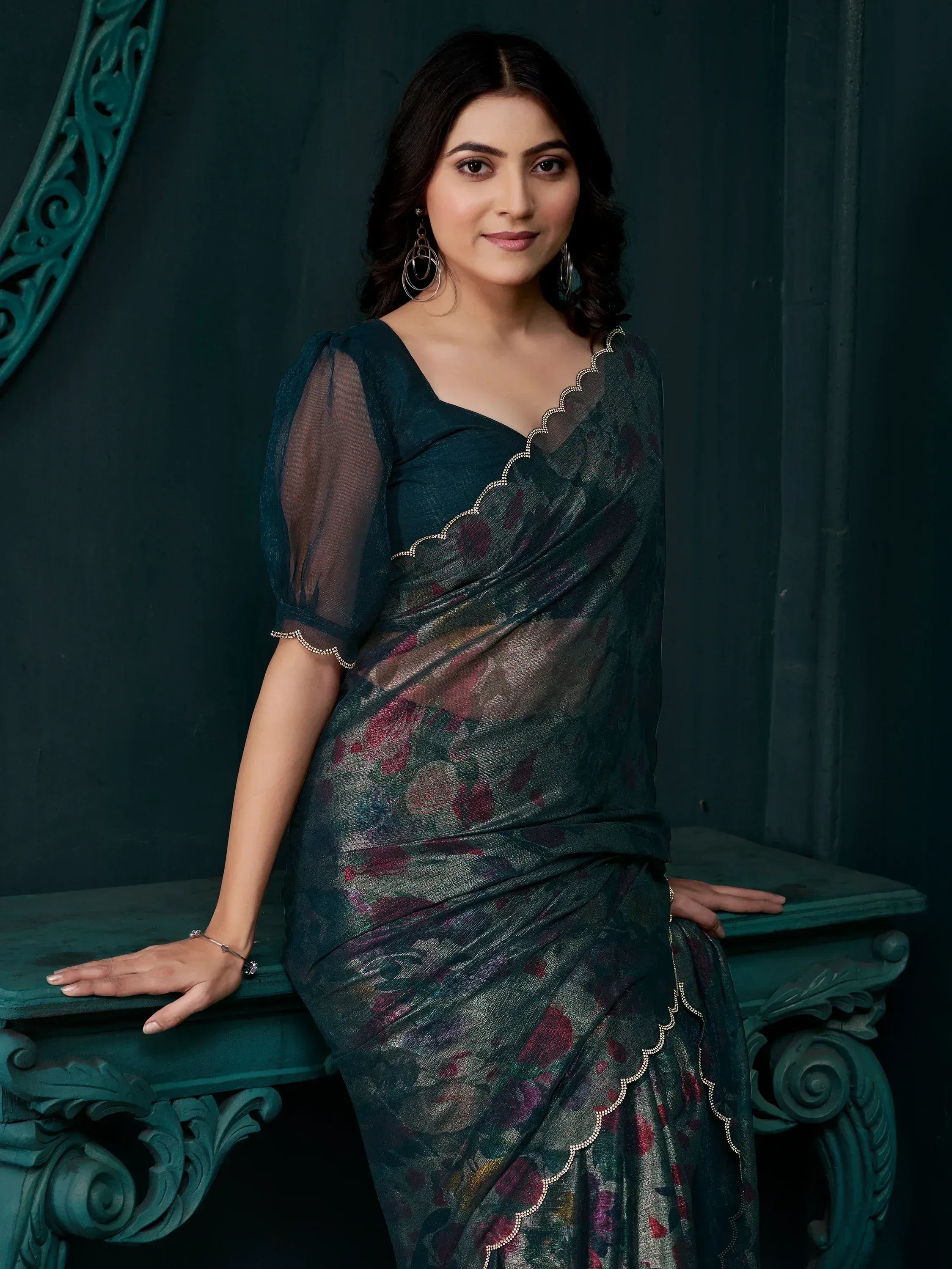 Elegant dark green floral saree with sheer sleeves and scalloped border, perfect for ethnic occasions
