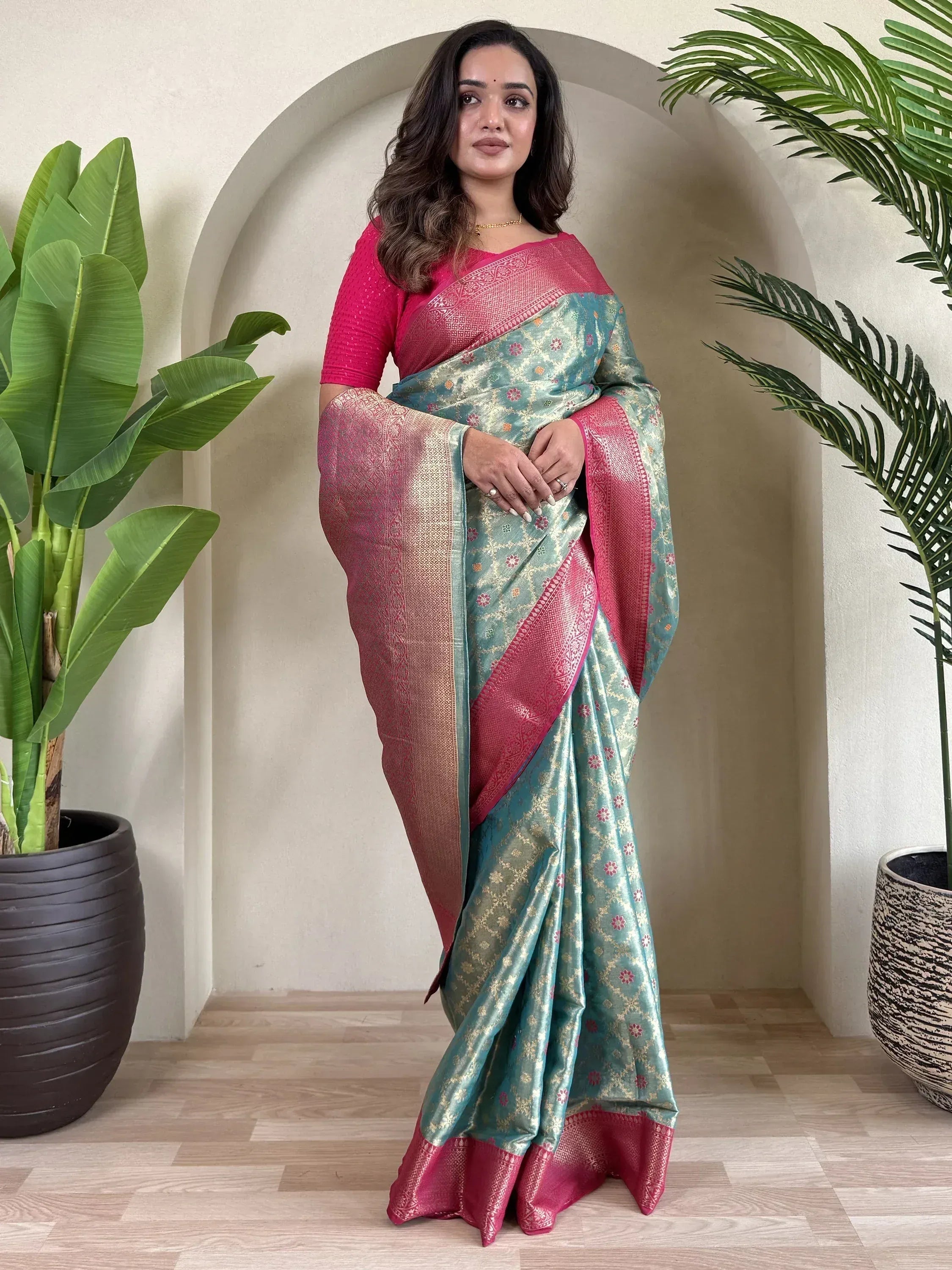 Teal and pink designer saree with gold floral motifs, perfect for Indian ethnic wear occasions