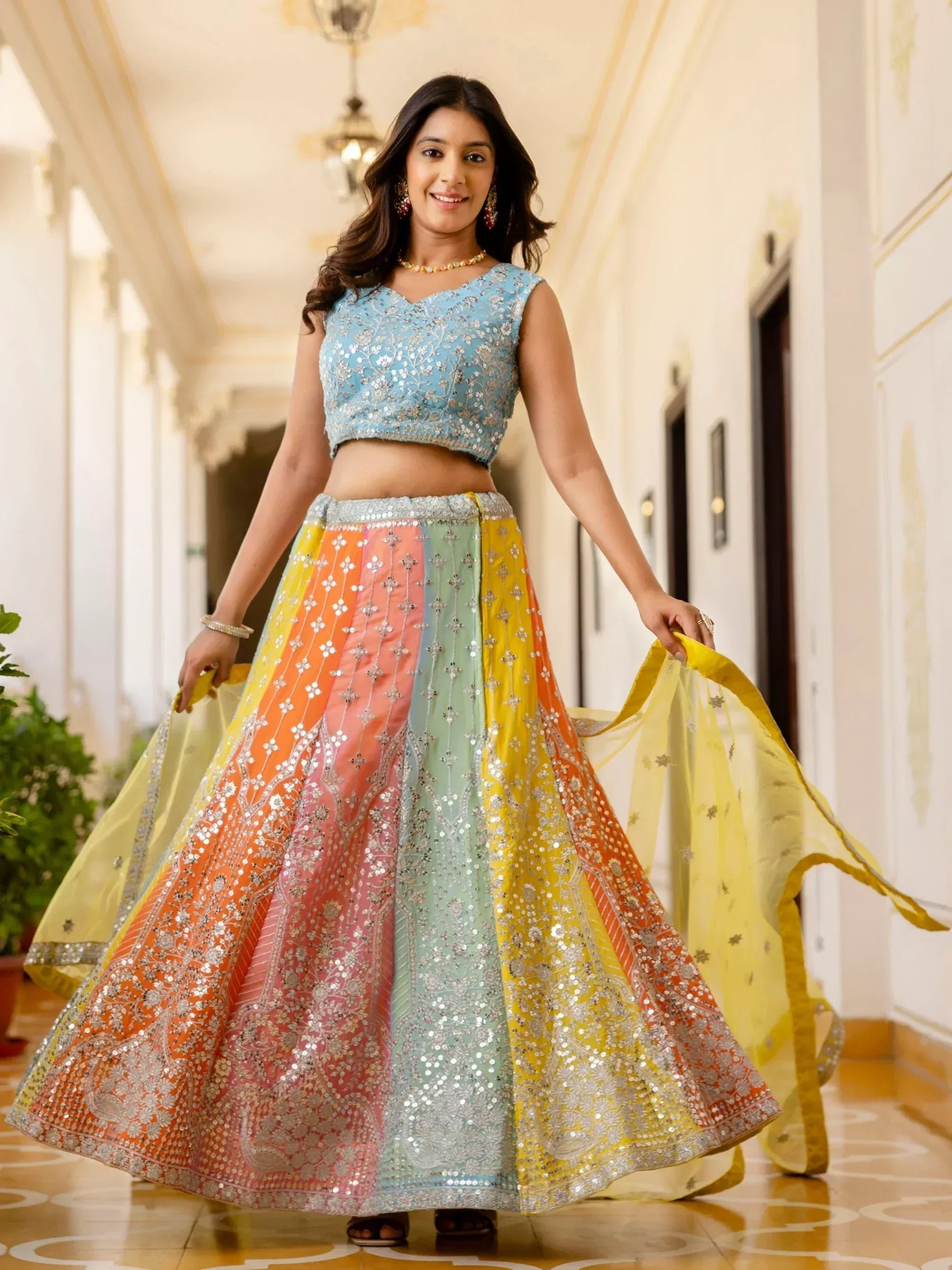Woman in colorful embroidered lehenga choli with sequins, perfect for Indian ethnic wear events