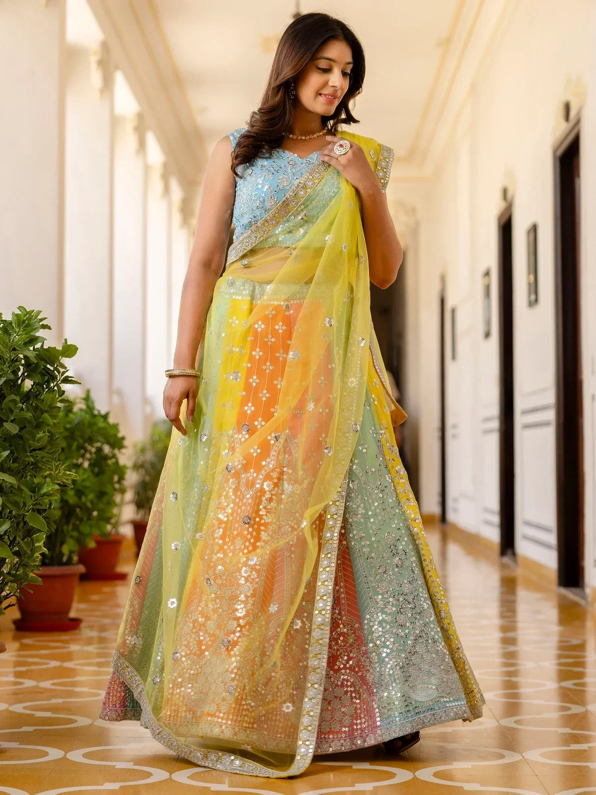 Woman in colorful embroidered lehenga choli with yellow dupatta, Indian ethnic wear