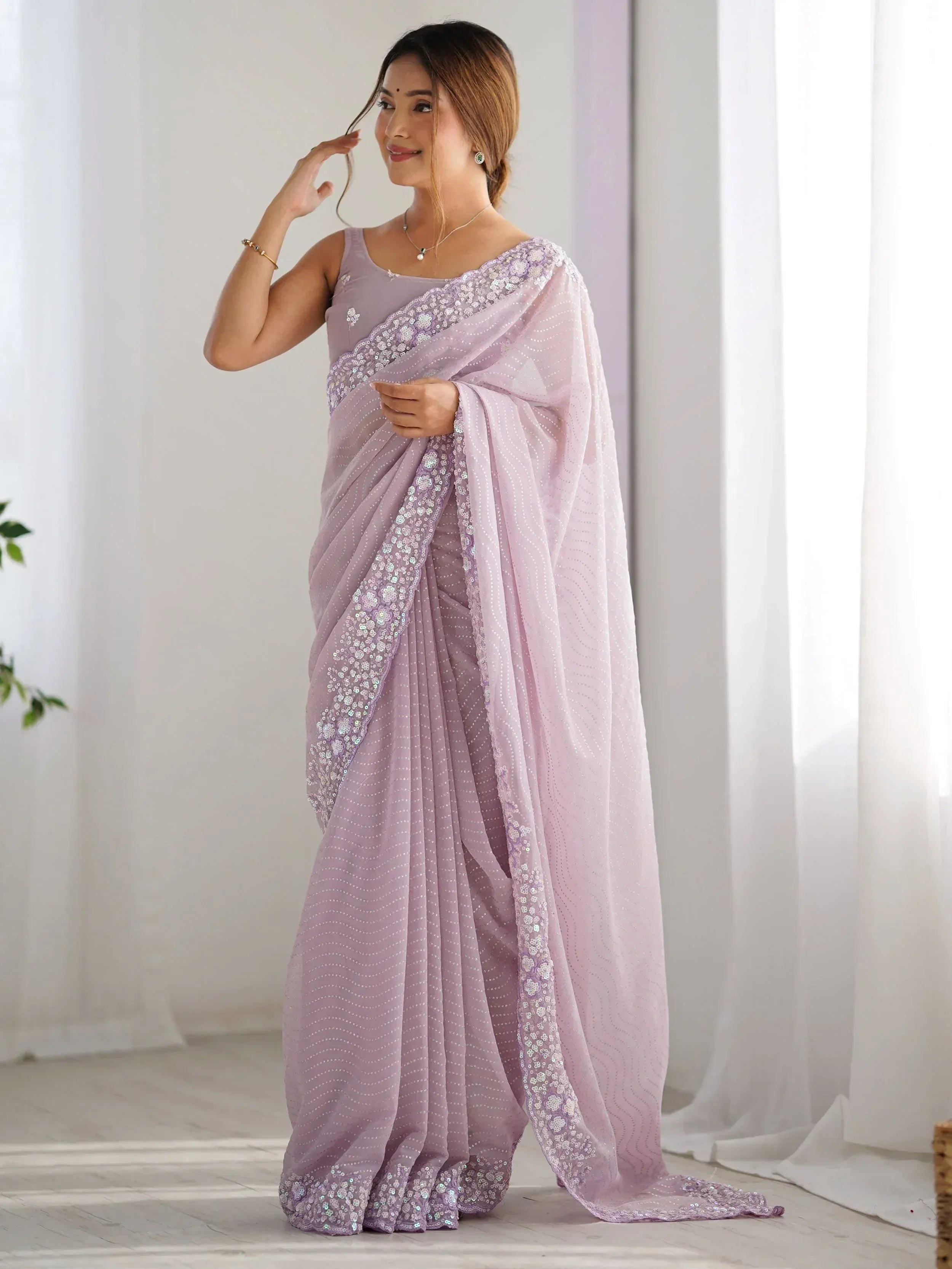 Lavender ethnic saree with sequin embroidery and floral border, perfect for Indian occasions
