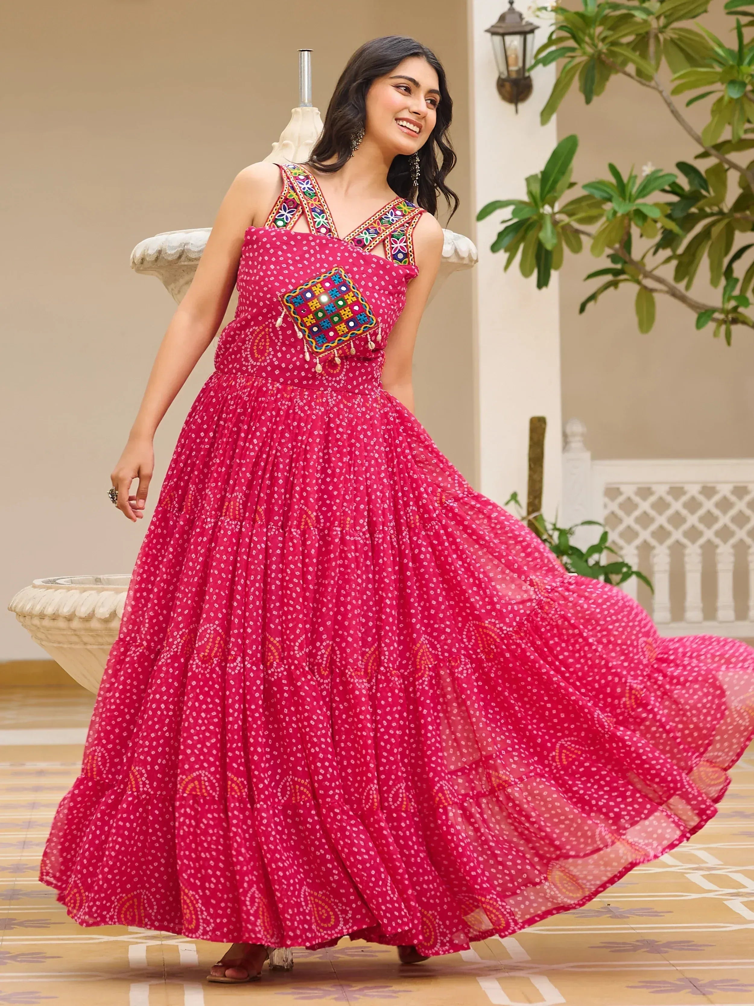 Pink ethnic gown with mirror work and floral embroidery, perfect for Indian festive occasions