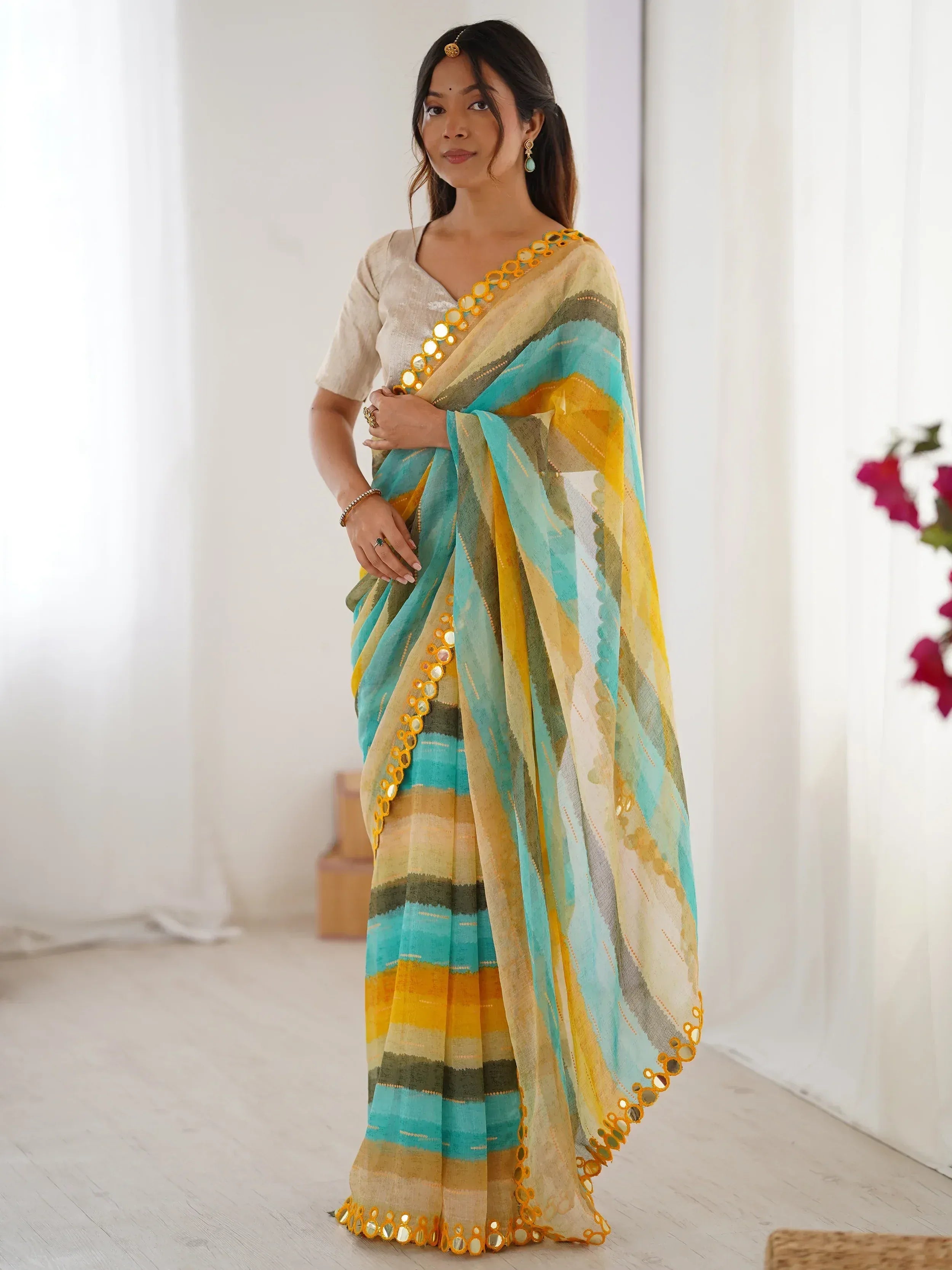 Stylish turquoise and yellow striped saree with mirror work border, perfect for ethnic occasions