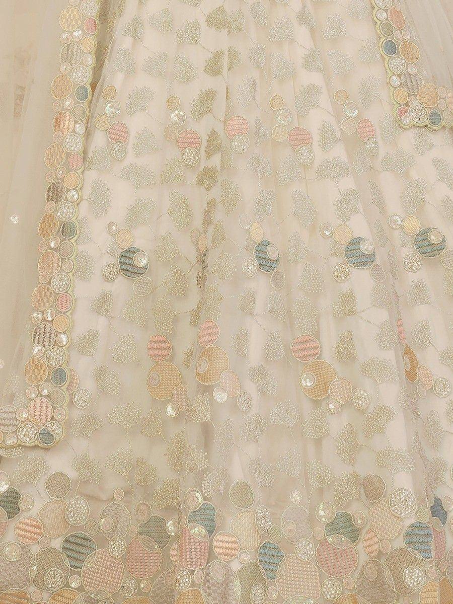 Cream ethnic lehenga with colorful circular embroidery and sequin detailing for festive occasions