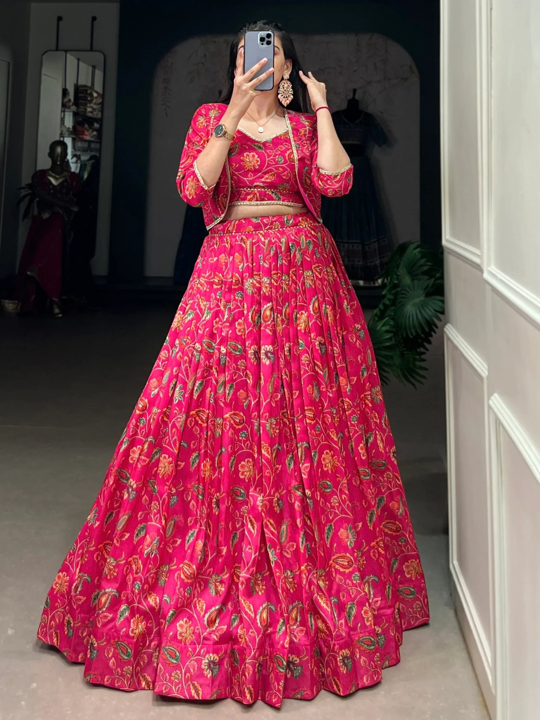 Vibrant pink floral lehenga choli with gold trim, perfect for Indian ethnic wear and festive occasions.