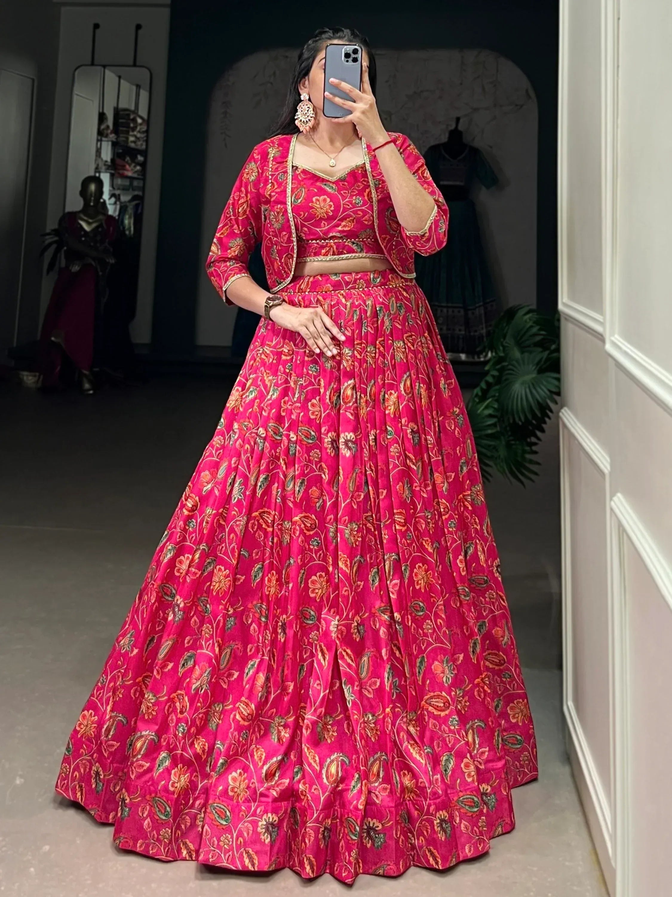 Vibrant pink floral lehenga choli with gold trim, perfect for Indian ethnic occasions and festive wear.