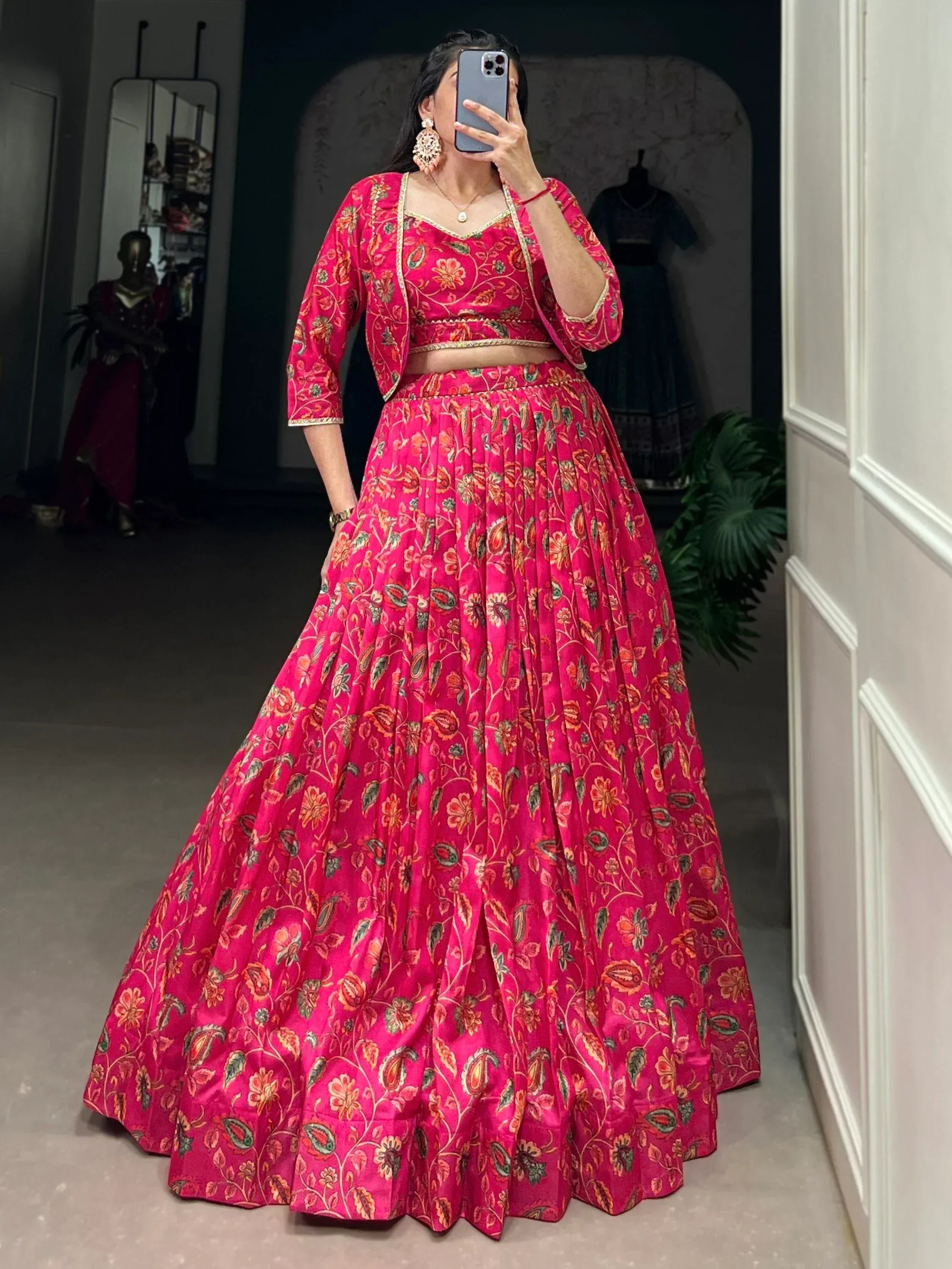 Vibrant pink floral lehenga choli with gold trim, perfect for Indian ethnic wear and festive occasions.