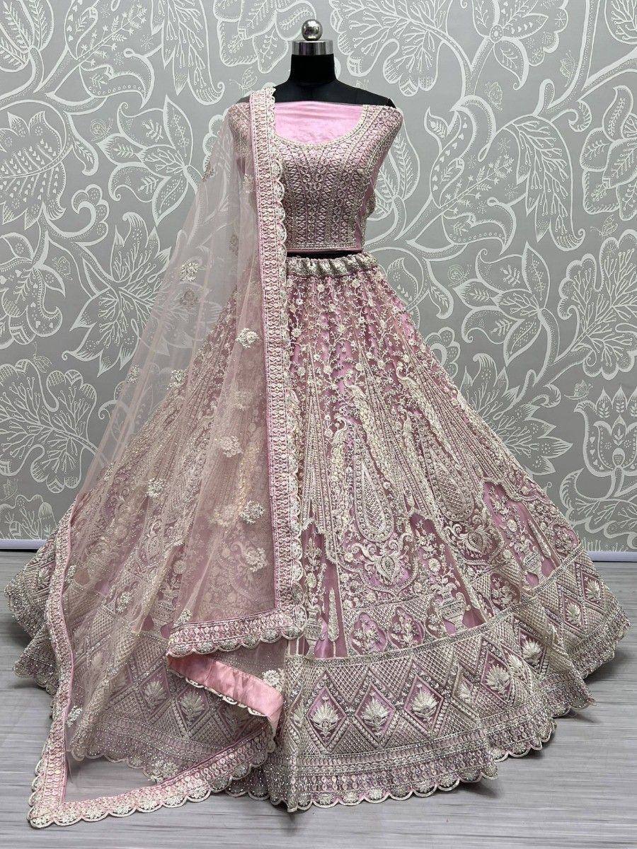 Pink designer lehenga choli with heavy embroidery and net dupatta, perfect for weddings and festive occasions.