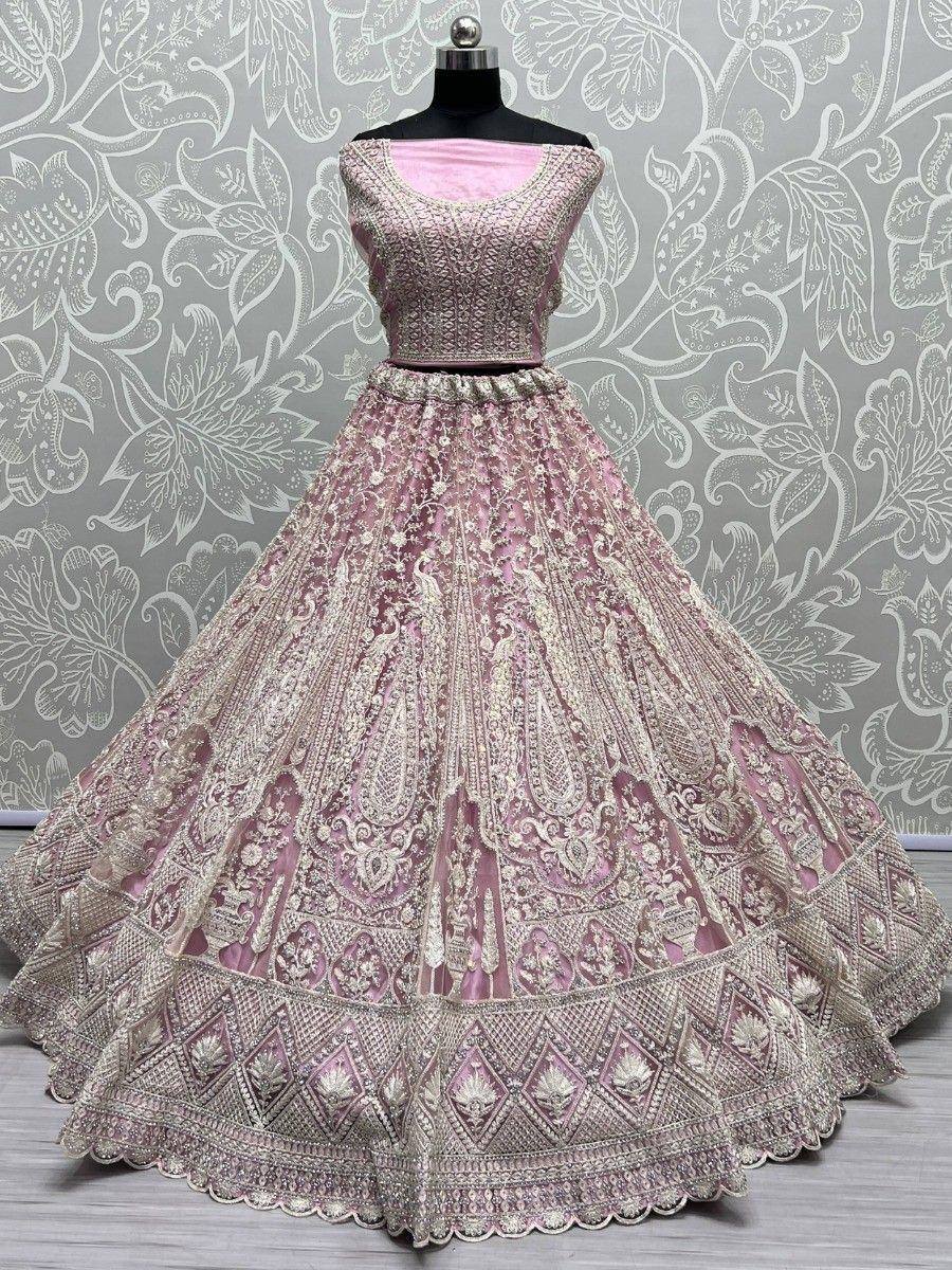Pink designer lehenga choli with intricate gold embroidery and scalloped hem, perfect for weddings and festivals