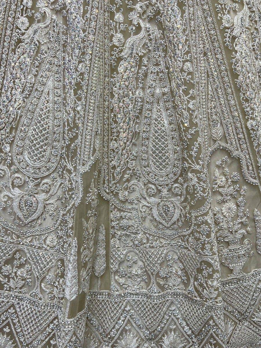 Exquisite silver embroidery on Indian ethnic lehenga with intricate floral and paisley designs