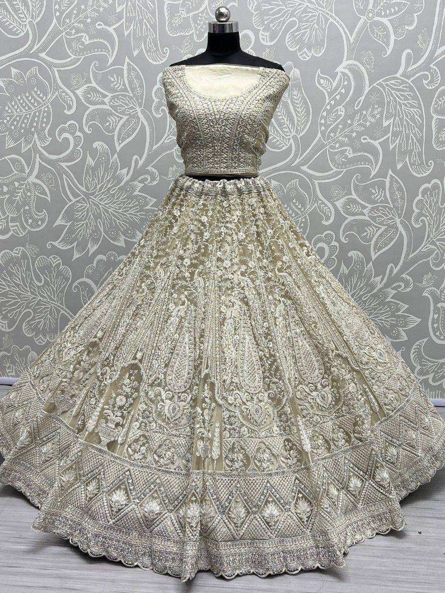 Elegant ivory lehenga choli with intricate embroidery, perfect for Indian weddings and festive occasions.