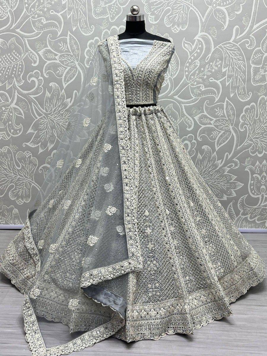 Elegant silver-grey lehenga choli with intricate embroidery and net dupatta, perfect for Indian ethnic occasions.