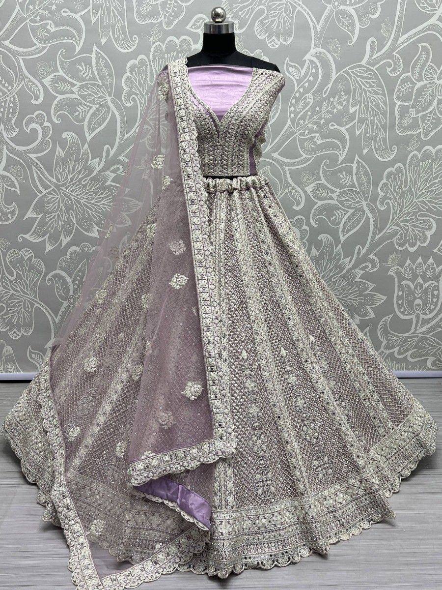 Elegant lavender lehenga choli with intricate embroidery and net dupatta, perfect for Indian weddings and festive occasions.