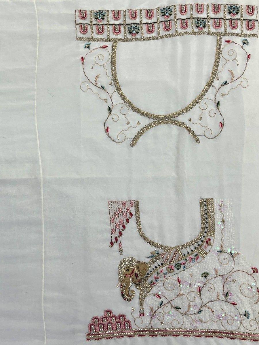 Embroidered white ethnic blouse with elephant motif and intricate gold detailing