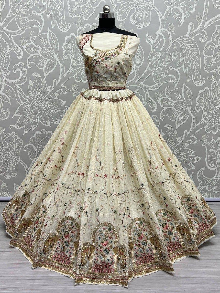Cream embroidered lehenga choli with floral and elephant motifs, perfect for Indian ethnic wear occasions