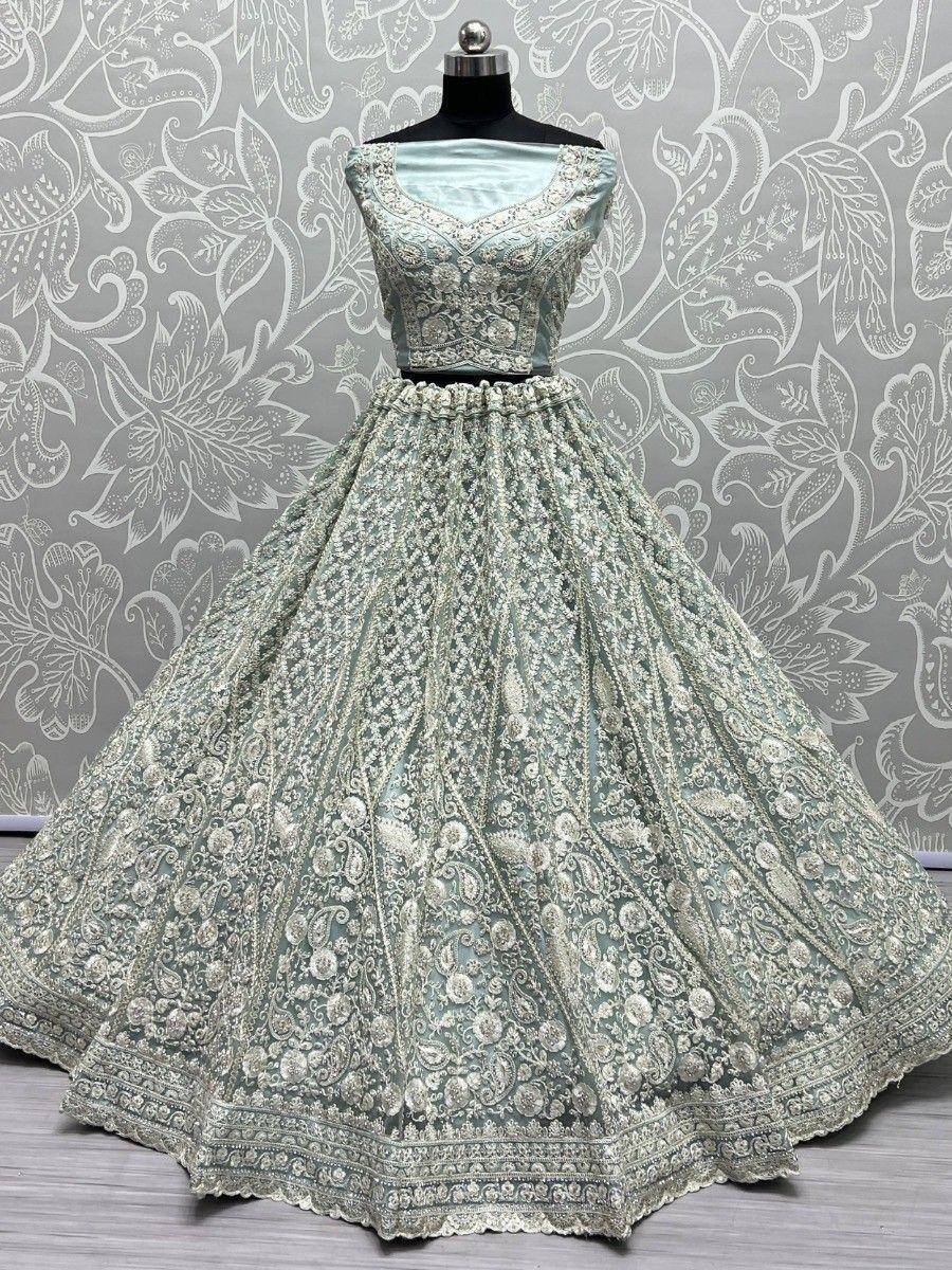 Mint green designer lehenga choli with heavy silver embroidery, perfect for Indian weddings and festive occasions.