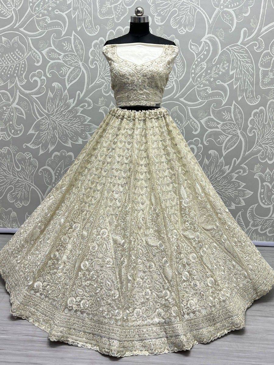 Elegant cream lehenga choli with intricate embroidery and flared skirt, perfect for Indian ethnic occasions.
