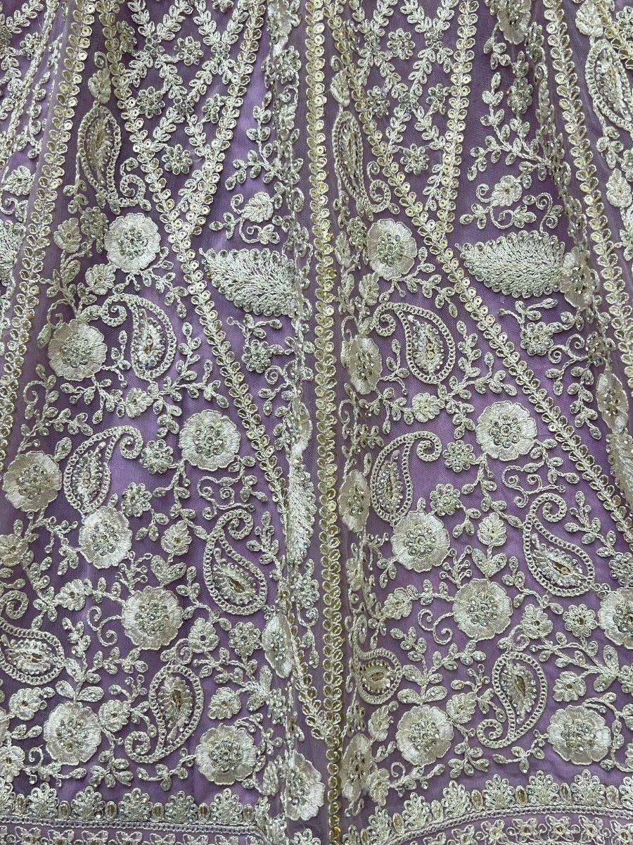 Purple ethnic gown with intricate gold floral and paisley embroidery, perfect for Indian weddings and festivals.