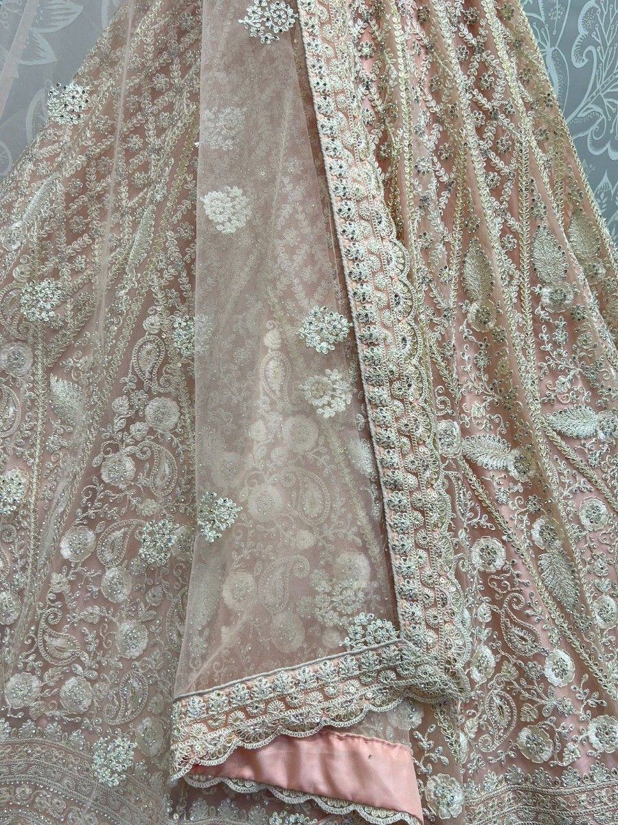 Pink designer lehenga choli with intricate silver embroidery and sheer dupatta, perfect for weddings