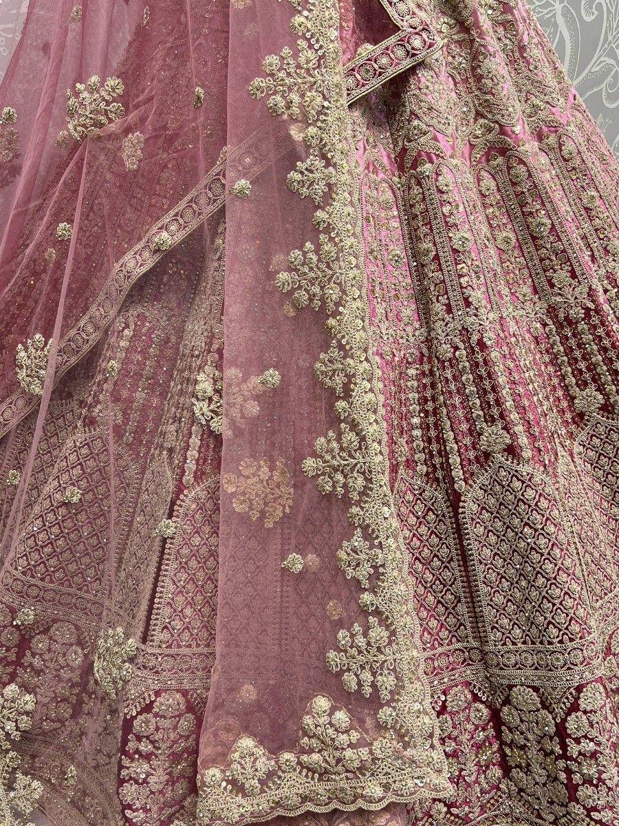 Luxury maroon lehenga choli with gold embroidery and net dupatta, perfect for Indian weddings and festive occasions.