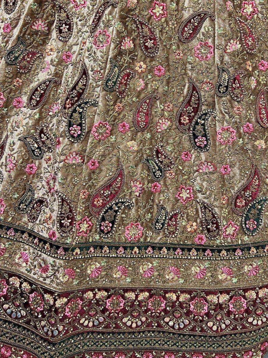 Luxury velvet lehenga with intricate paisley and floral embroidery in pink and gold, perfect for Indian ethnic wear.