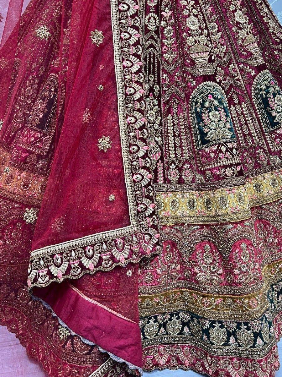 Luxury maroon lehenga choli with heavy gold embroidery and floral motifs, perfect for Indian weddings