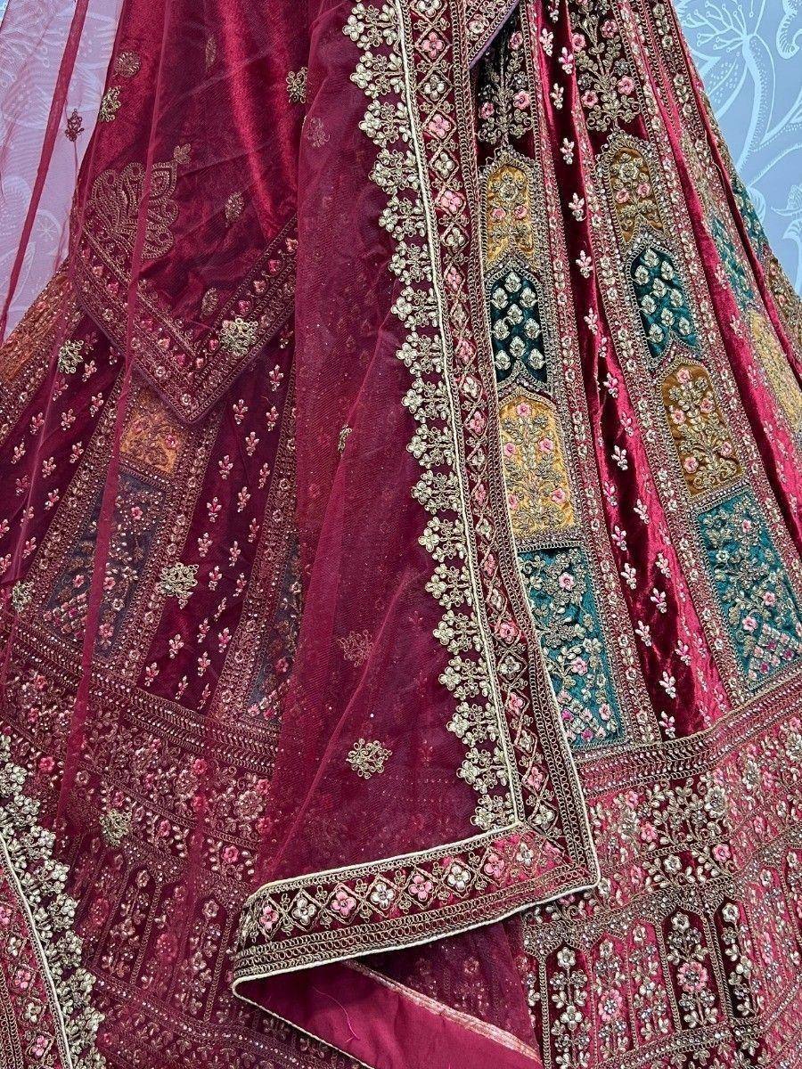 Luxury maroon velvet lehenga with intricate gold and floral embroidery, perfect for Indian weddings