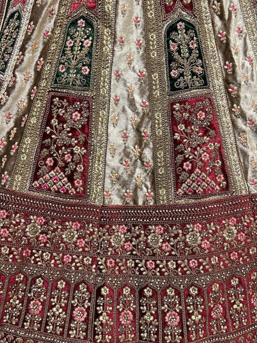 Luxury Indian lehenga with intricate gold embroidery, pink floral motifs, and velvet panels for weddings