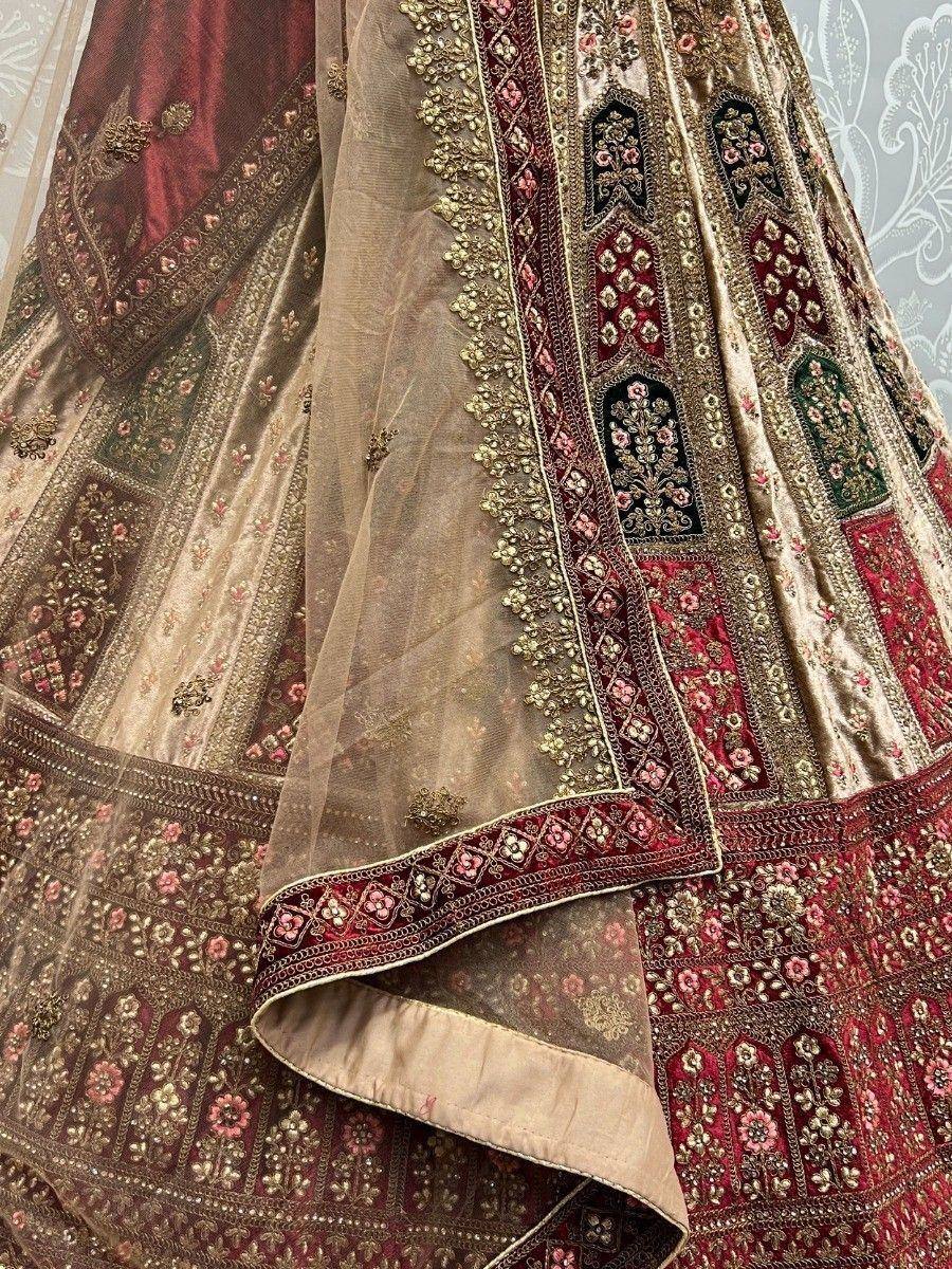 Luxury Indian lehenga choli with intricate gold and red embroidery, perfect for weddings and festive occasions.